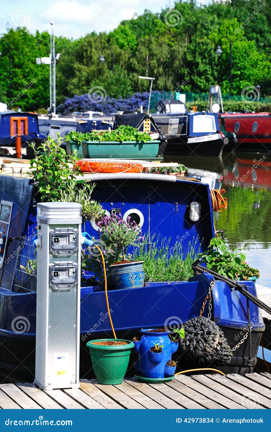 Narrowboat łączył dostawy prądu. Narrowboats na ich cumowaniach haczył do dostaw prądu w kanałowym basenie, Barton Marina, pod, Staffordshire, Anglia, UK, zachodnia europa