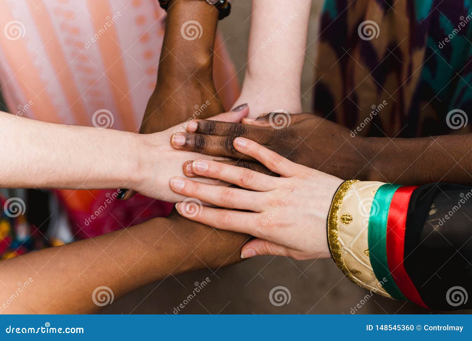 national diversity. people of different appearance and nationality stand in a circle together and hold hands. team building and pa