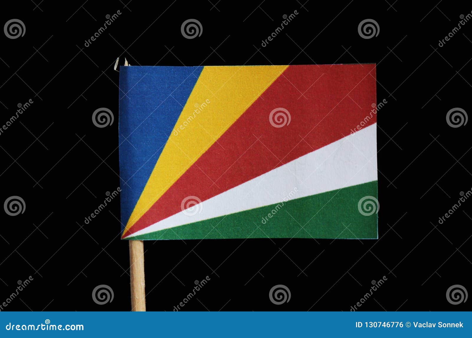 A National Flag Of Seychelles On Toothpick On Black Background Consists From Five Oblique Bands Of Blue Yellow Red White And G Stock Photo Image Of Developing East