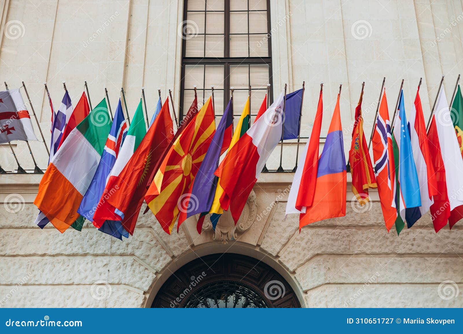 national flags of various countries flying in the wind. colorful flags from different countries. flags organization for