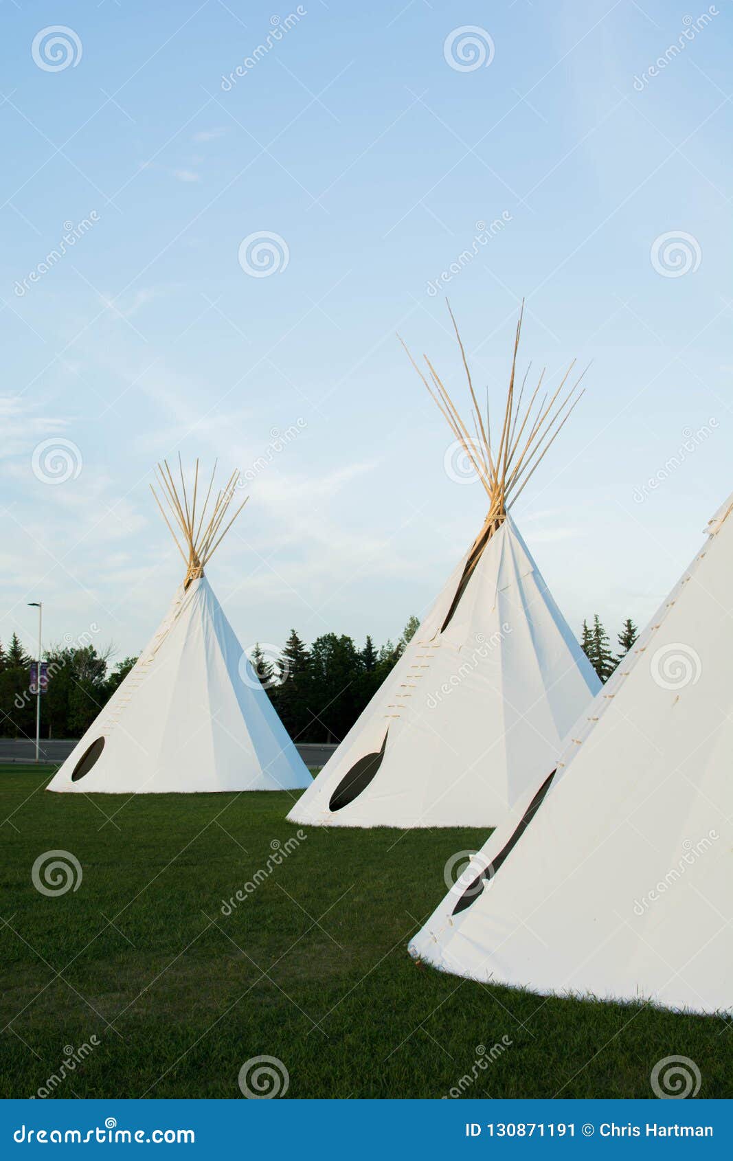 native american tepees on the prairies at sunset
