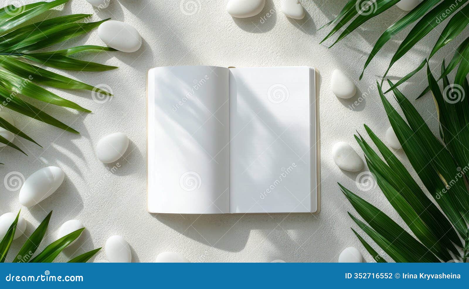 natural arrangement of pebbles and greenery with a blank canvas ideal for creative ideas