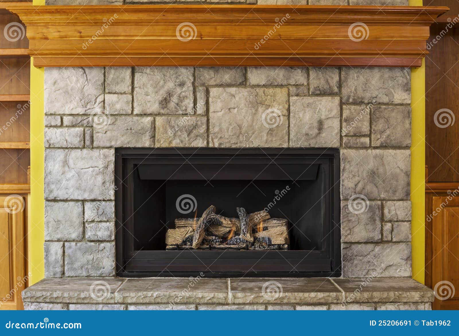 Natural Gas Insert Fireplace With Stone And Wood Stock Image