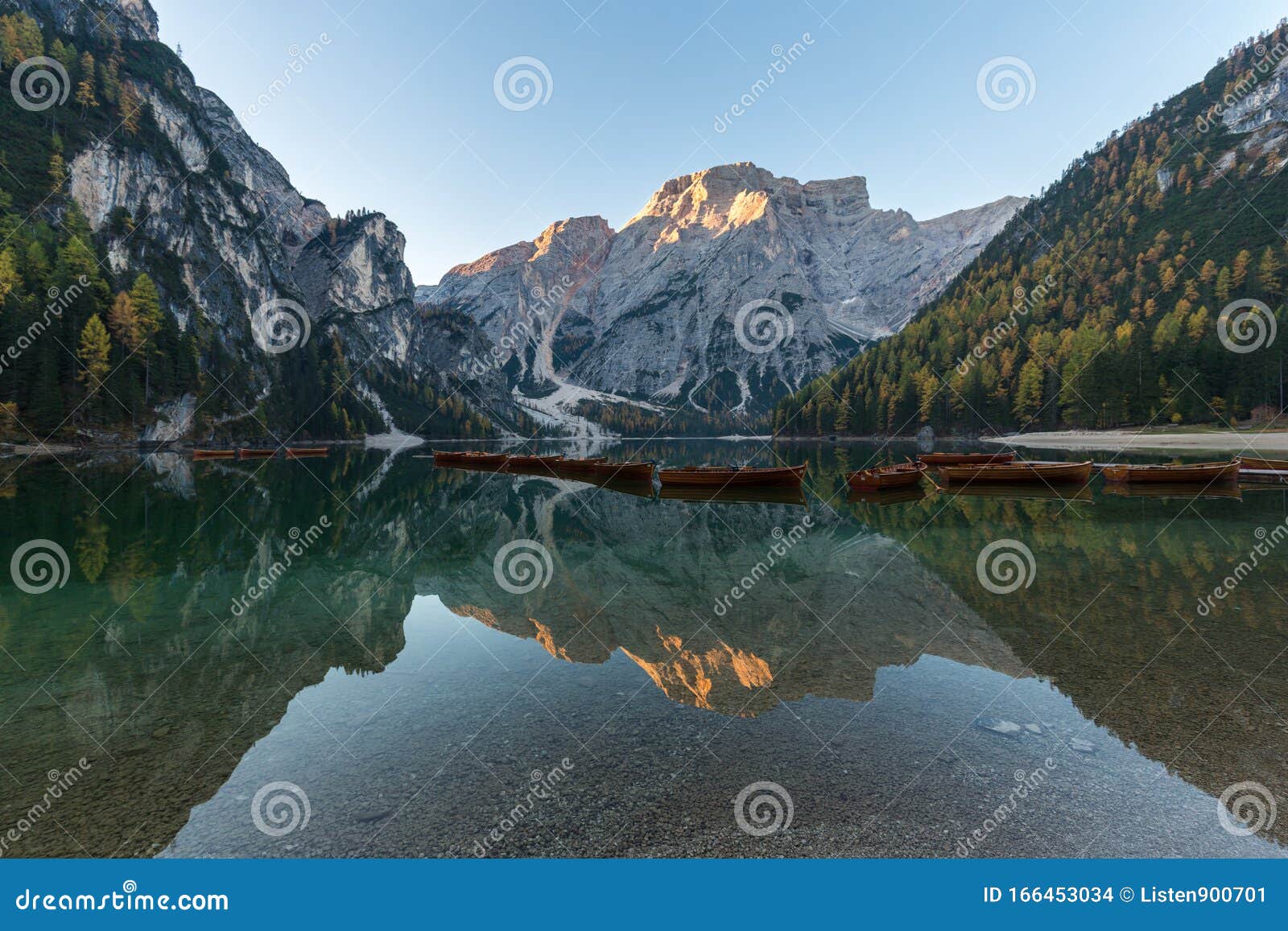 natural landscapes of the lake braies lago di braies with morning fog and reflection of the mountain peak in dolomites, italy