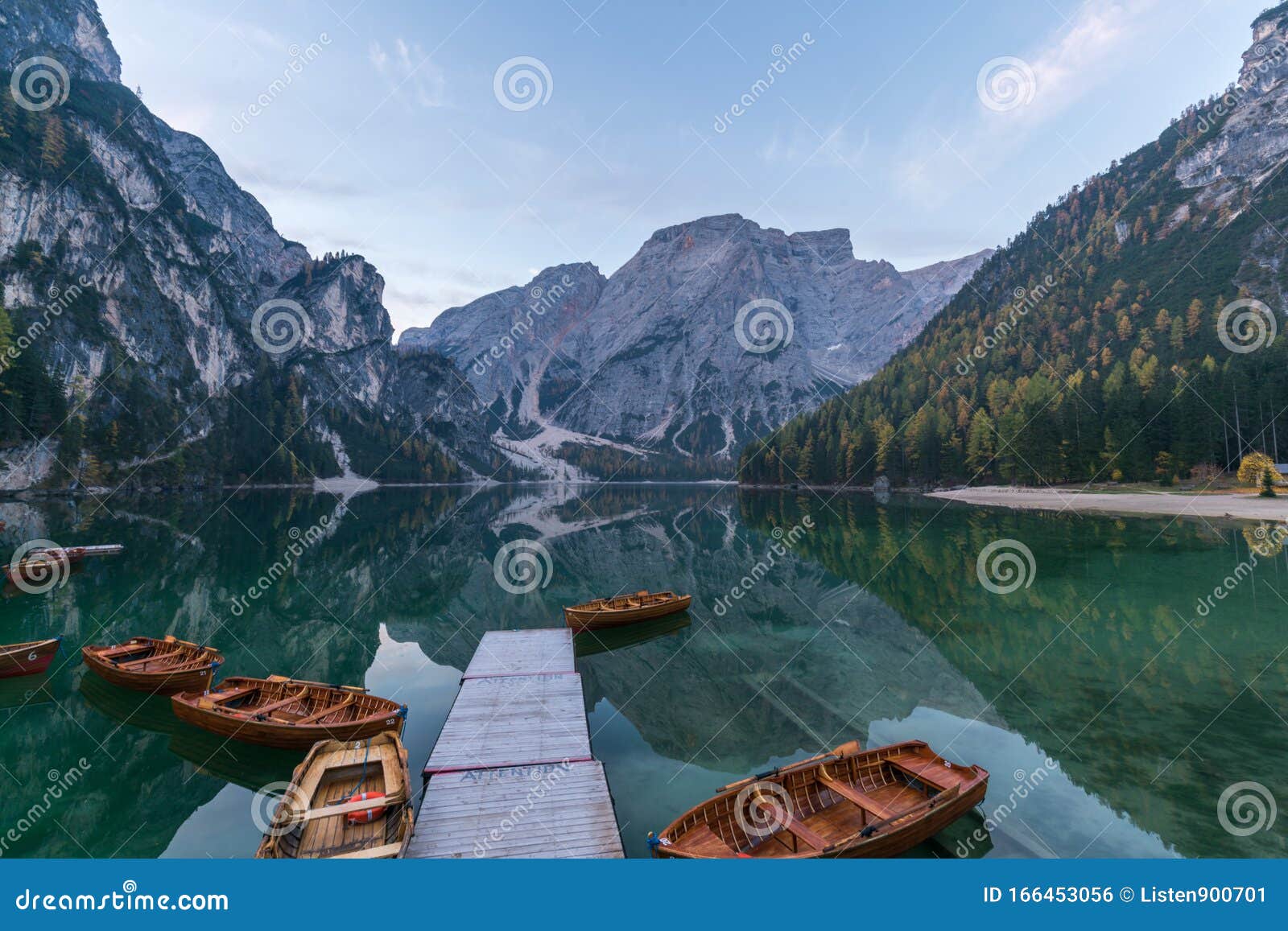 natural landscapes of the lake braies lago di braies with morning fog and reflection of the mountain peak in dolomites, italy