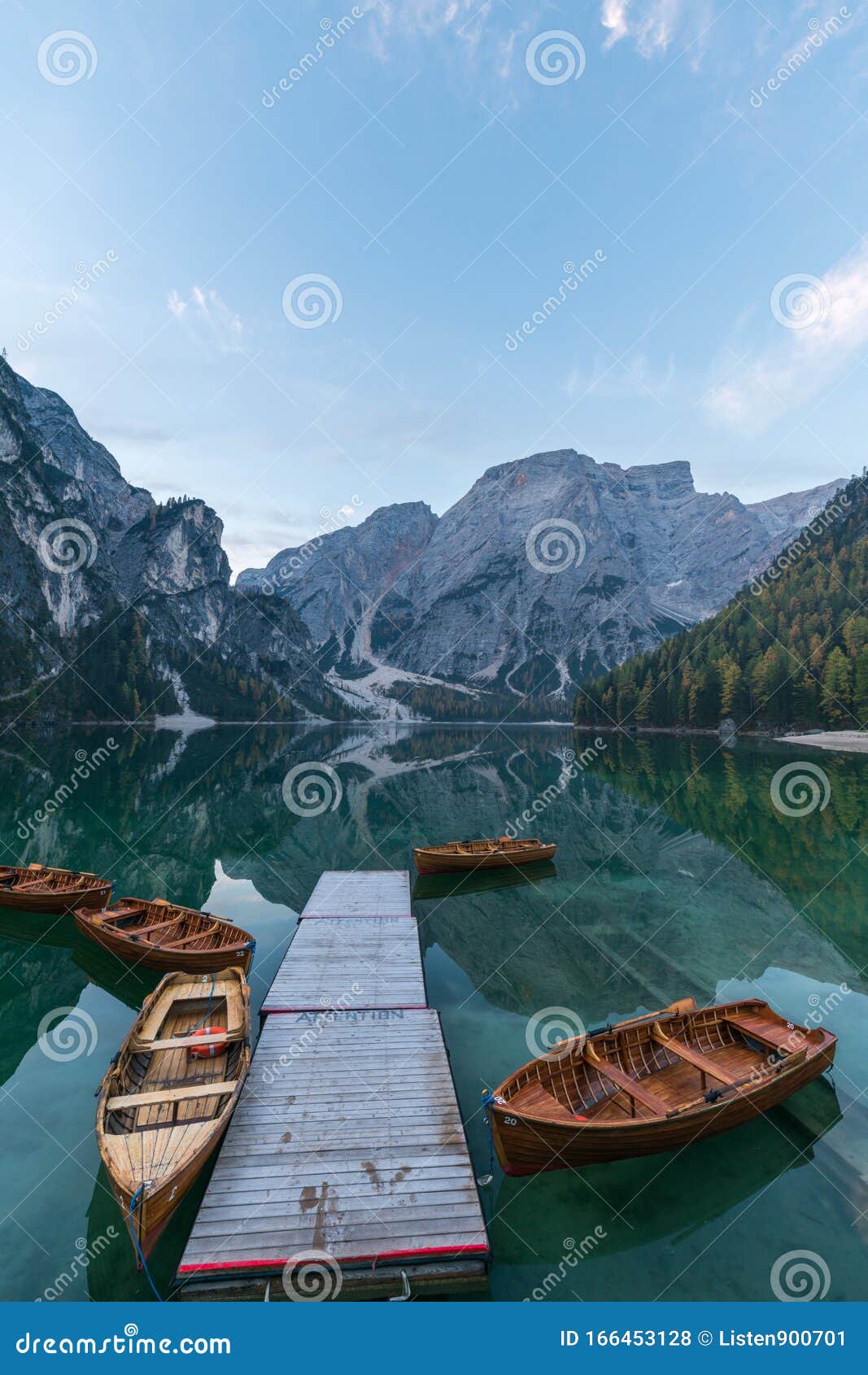 natural landscapes of the lake braies lago di braies with morning fog and reflection of the mountain peak in dolomites, italy