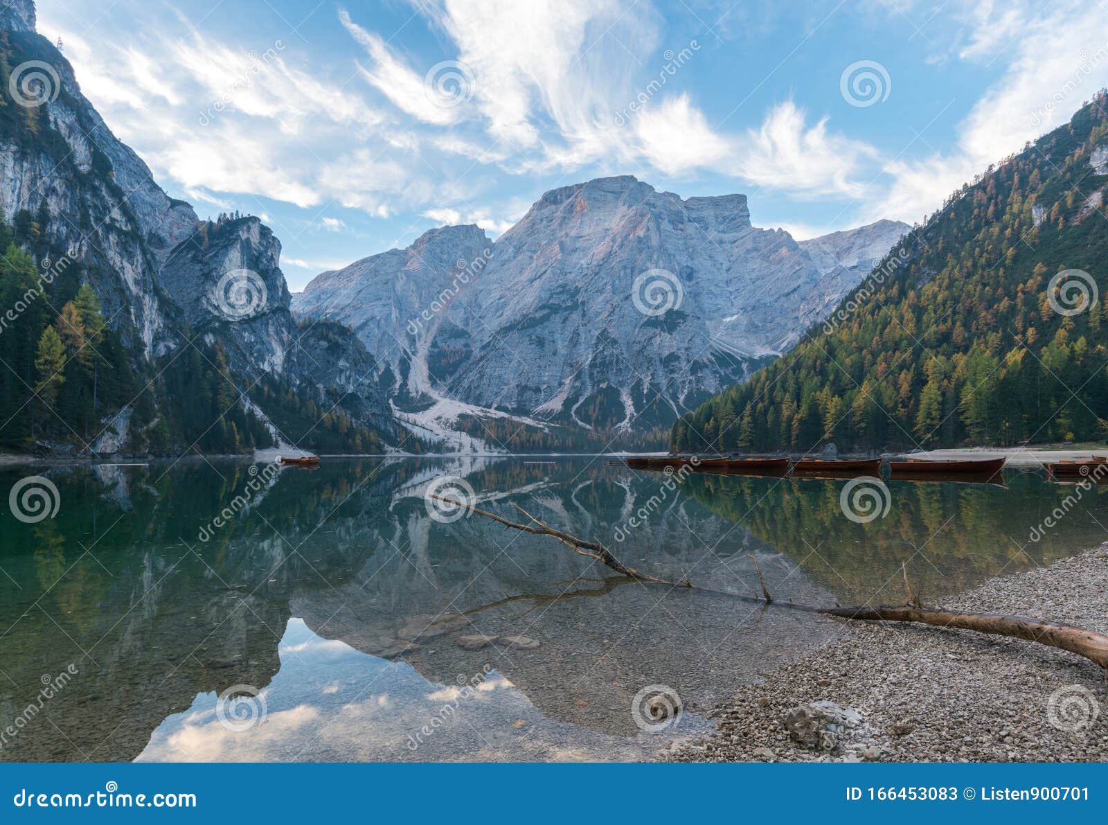 natural landscapes of the lake braies lago di braies with morning fog and reflection of the mountain peak in dolomites, italy