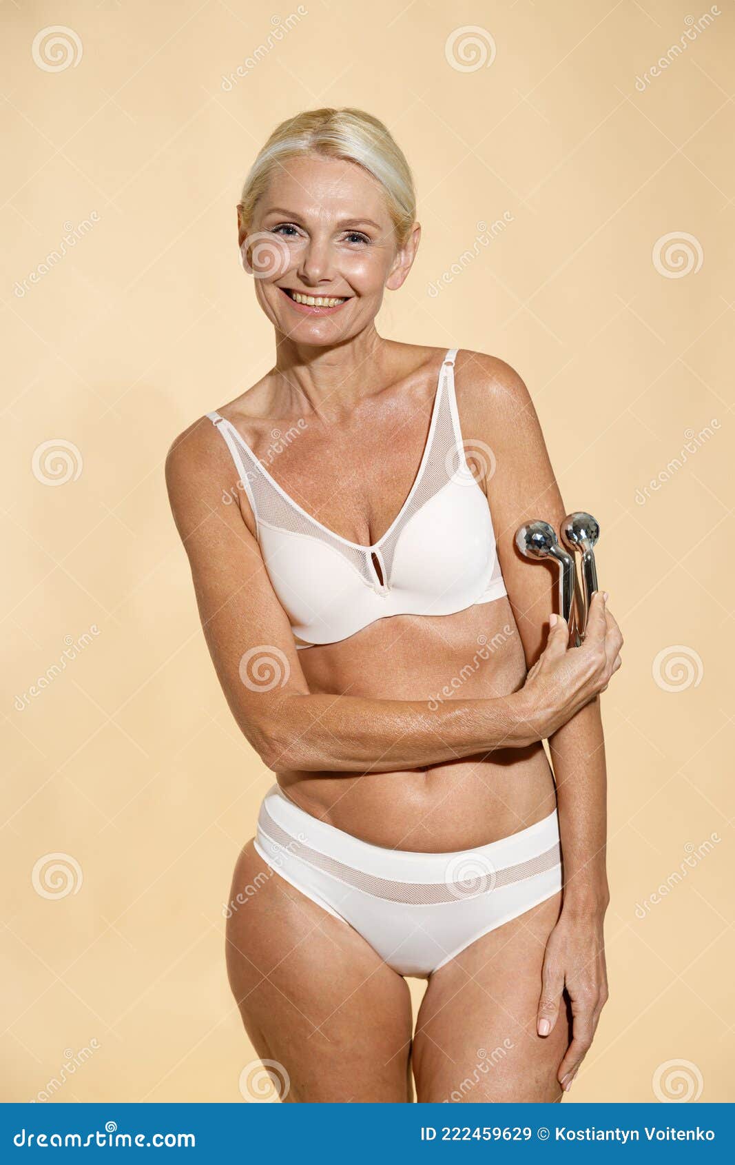 Middle-aged woman posing wearing a blue t-shirt and panties stock photo