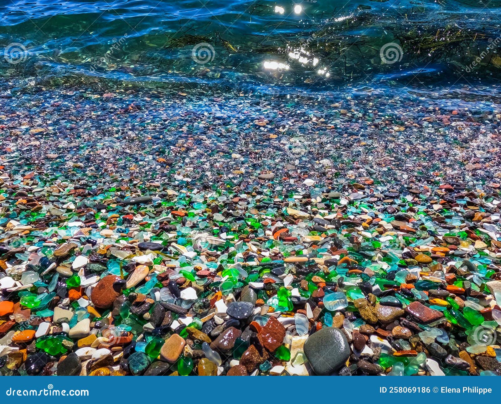 Colorful gemstones on a beach. Polish textured sea glass and