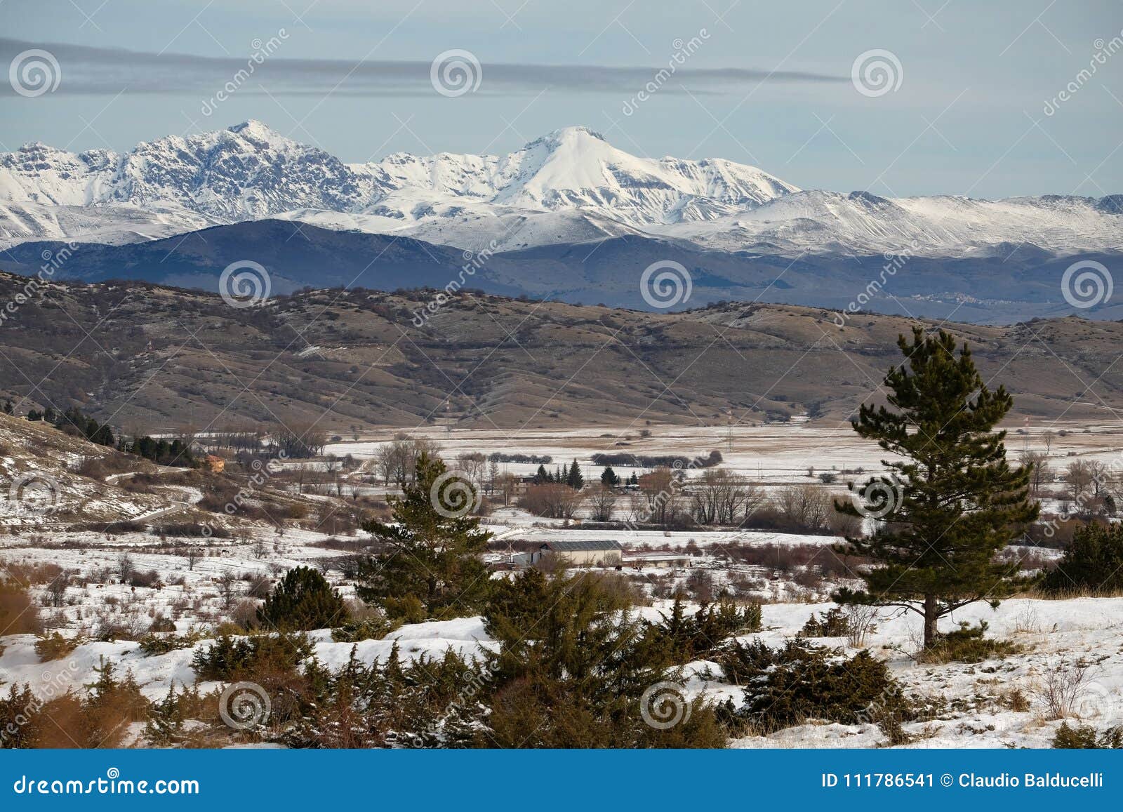 natural snowy landscape with mountains of gran sasso in the back