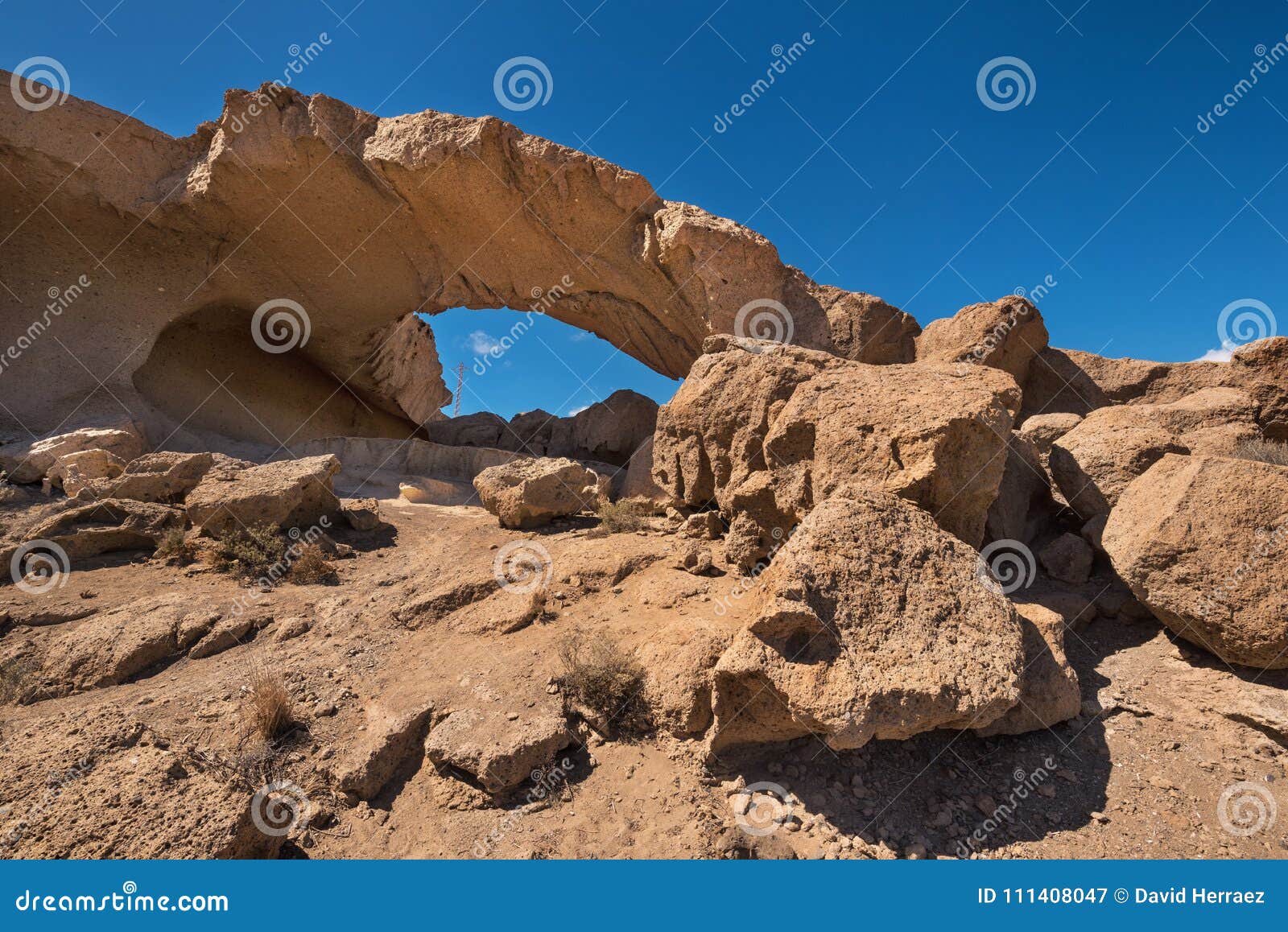 natural volcanic rock arch formation in desertic landscape in tenerife, canary islands, spain.