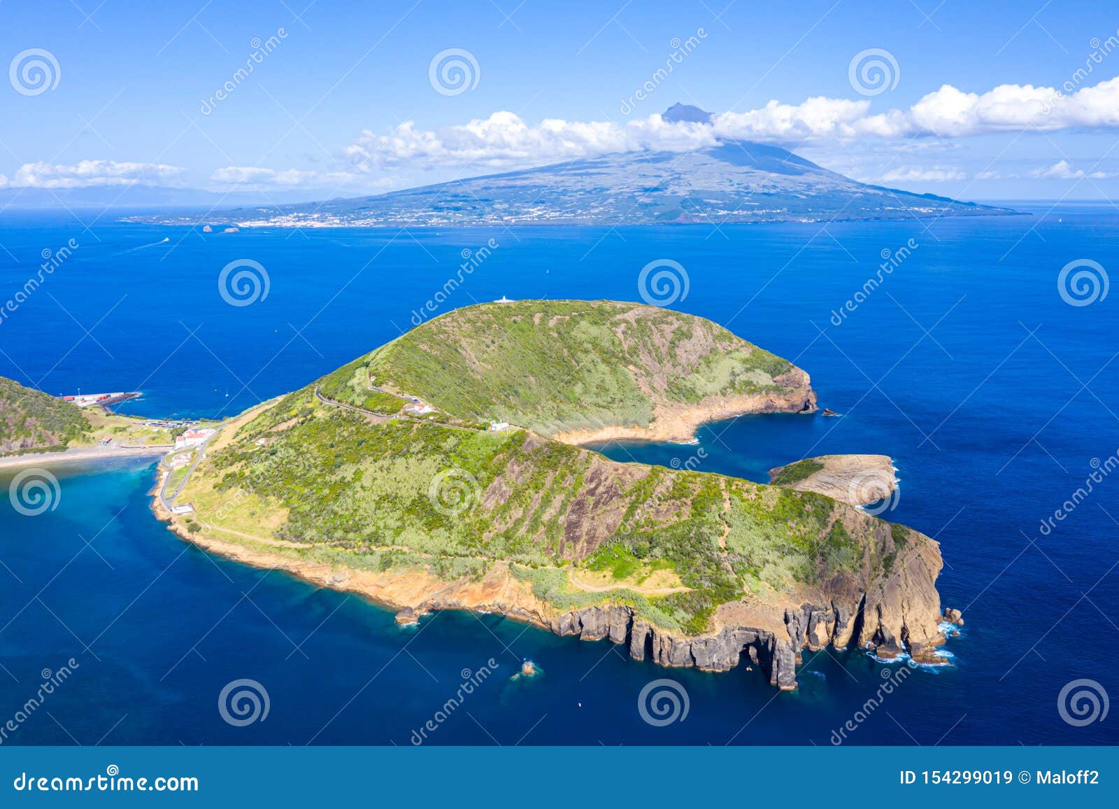 extinct volcano craters of caldeirinhas, mount guia, horta, faial island with the peak of pico volcanic mountain, azores, portugal