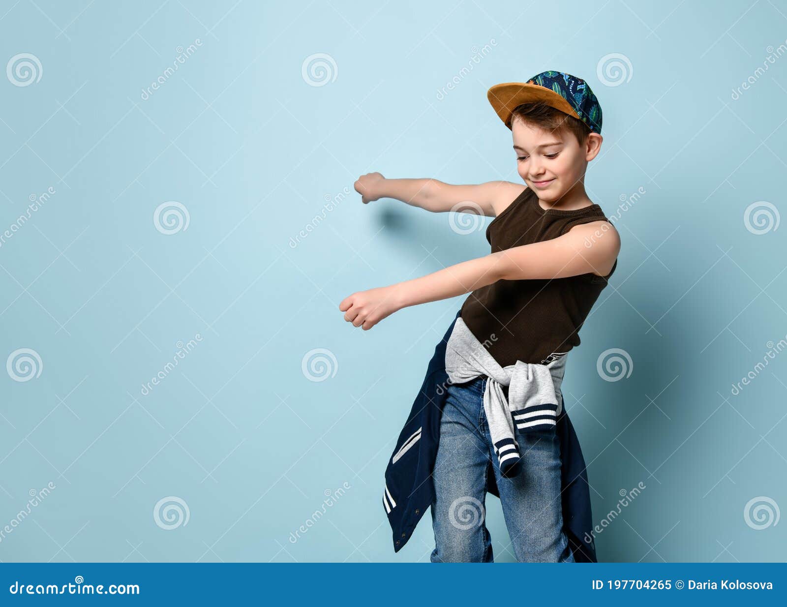 Naughty Schoolboy in Stylish Cap Jumping in Place Looking Down Under ...