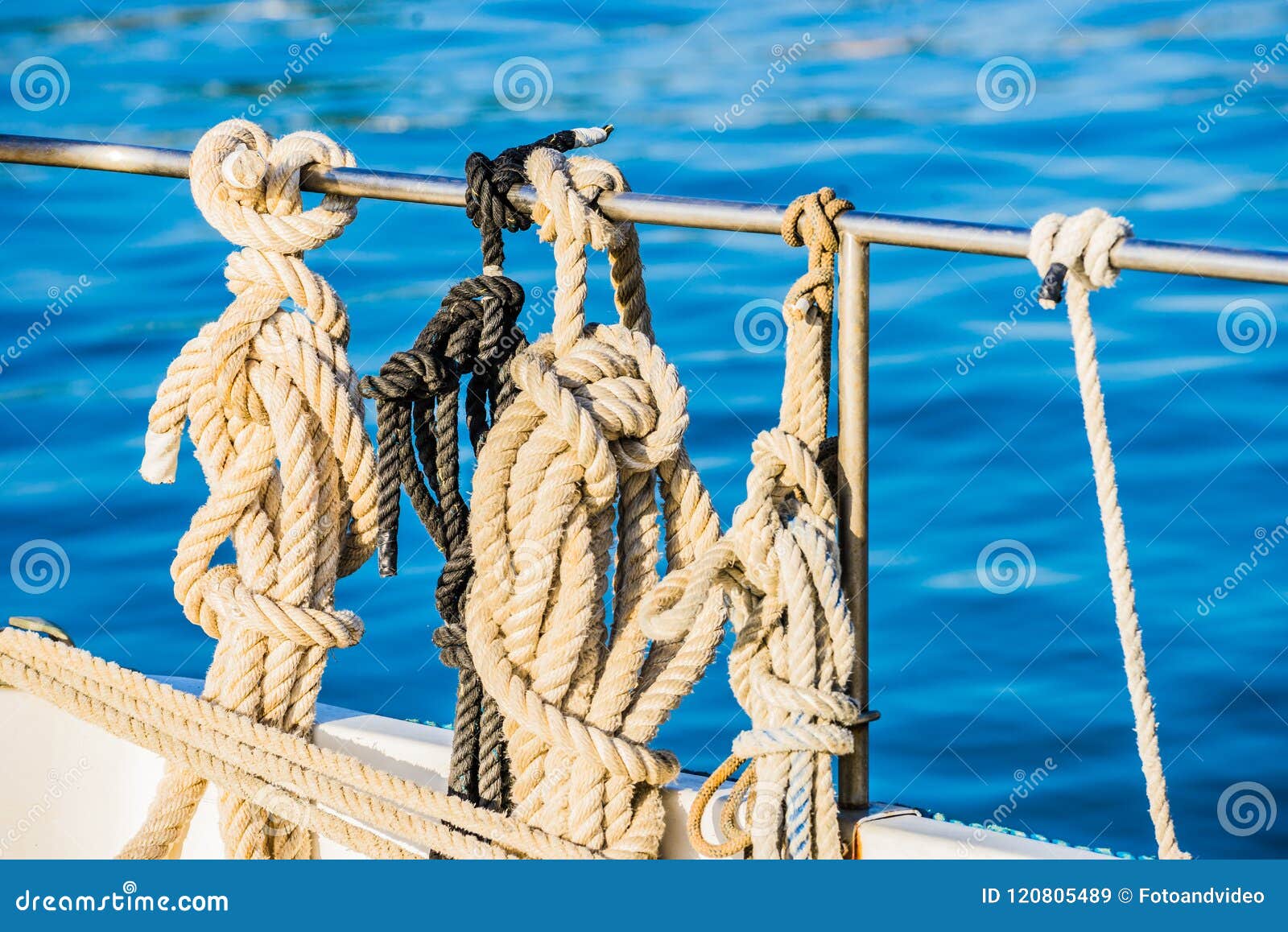 Nautical Ropes Knotted on Railing of Sailboat Deck Stock Image