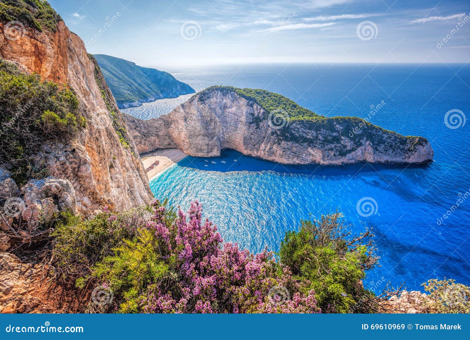 navagio beach with shipwreck and flowers against sunset on zakynthos island in greece