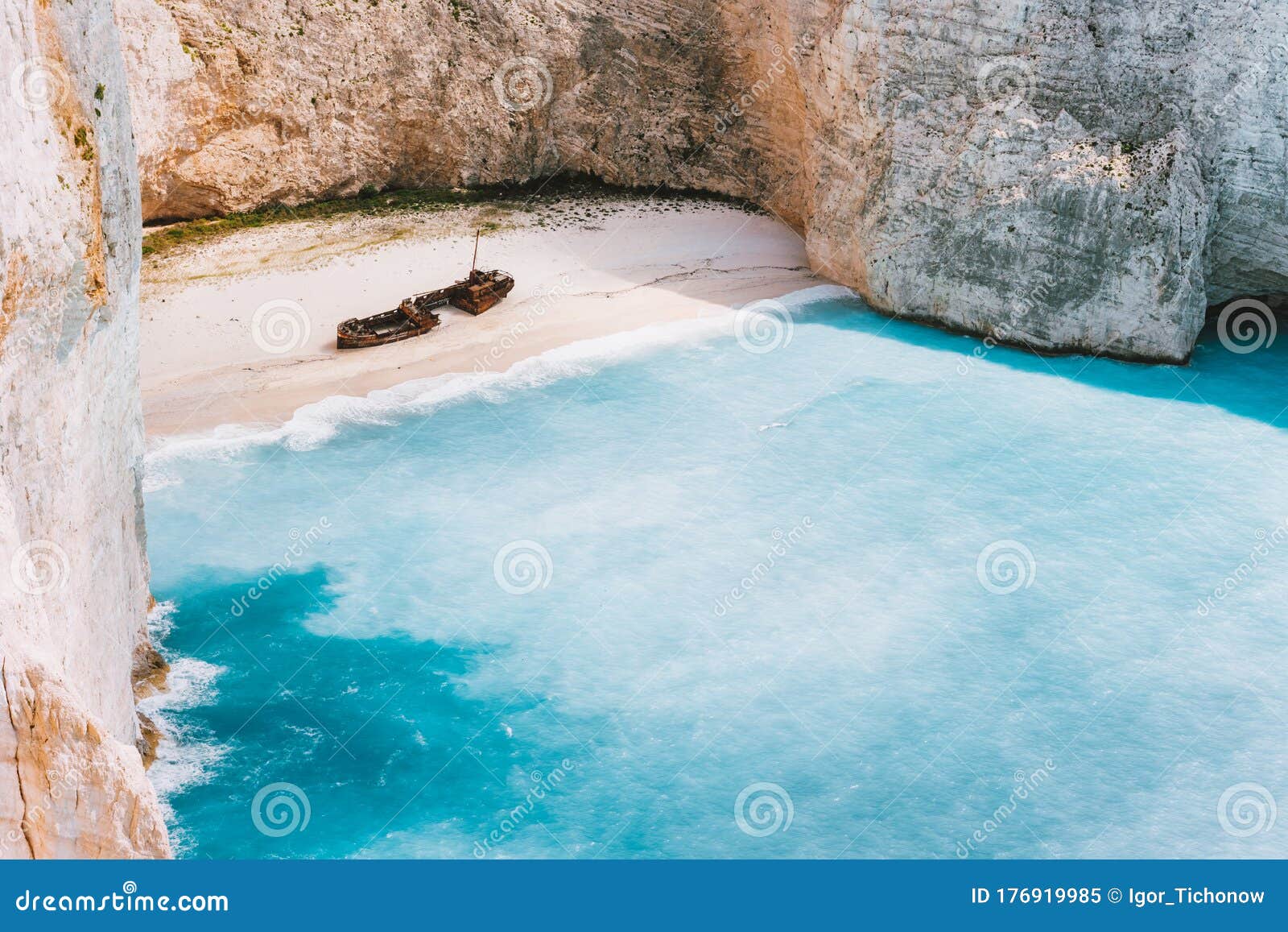 navagio beach with turquoise blue sea water surrounded by huge white limestone cliffs. famous landmark location on