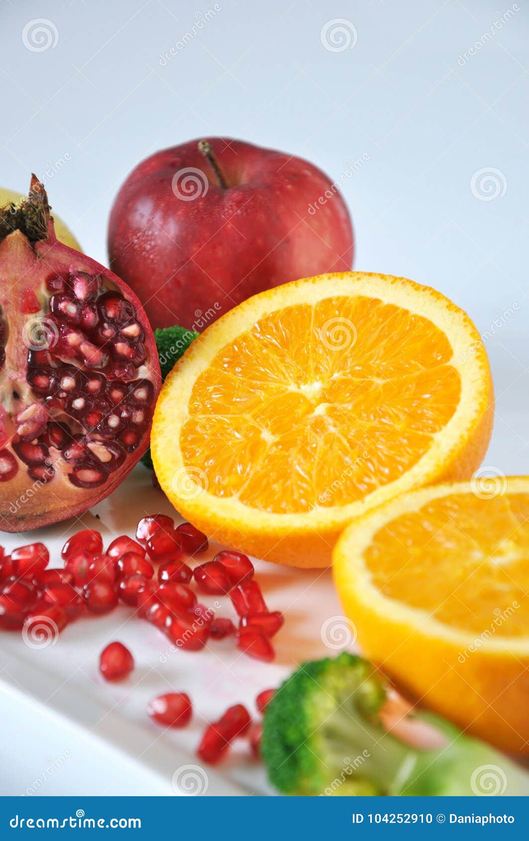 navel orange with pomegranate and red apple stock photo - image of