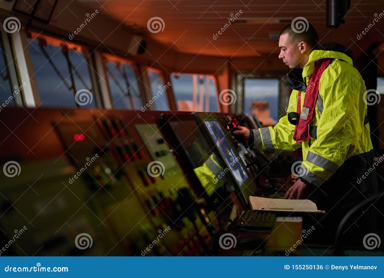 navigator. pilot, captain as part of ship crew performing daily duties with vhf radio, binoculars on board of modern ship with