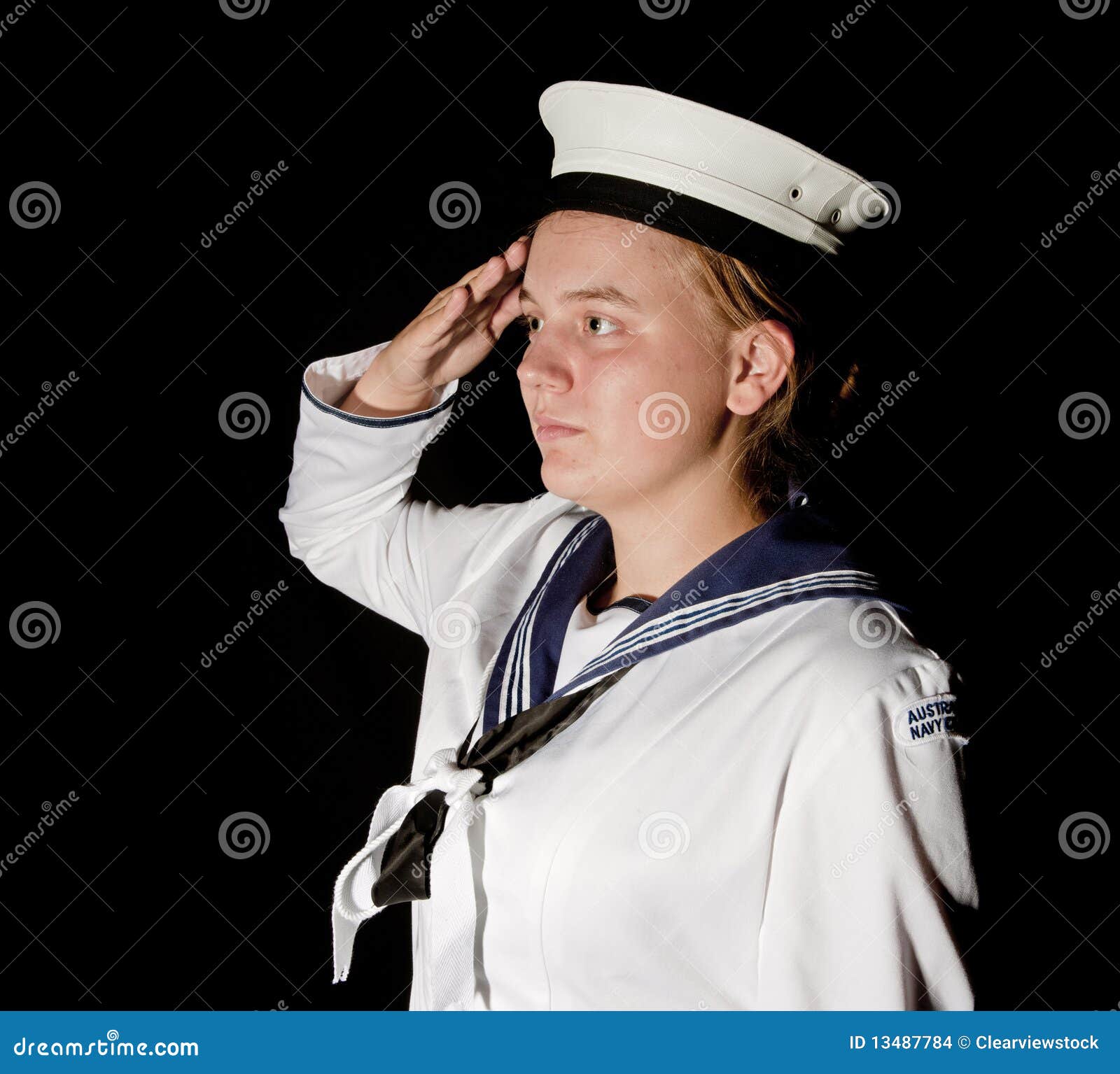 navy seaman saluting on black