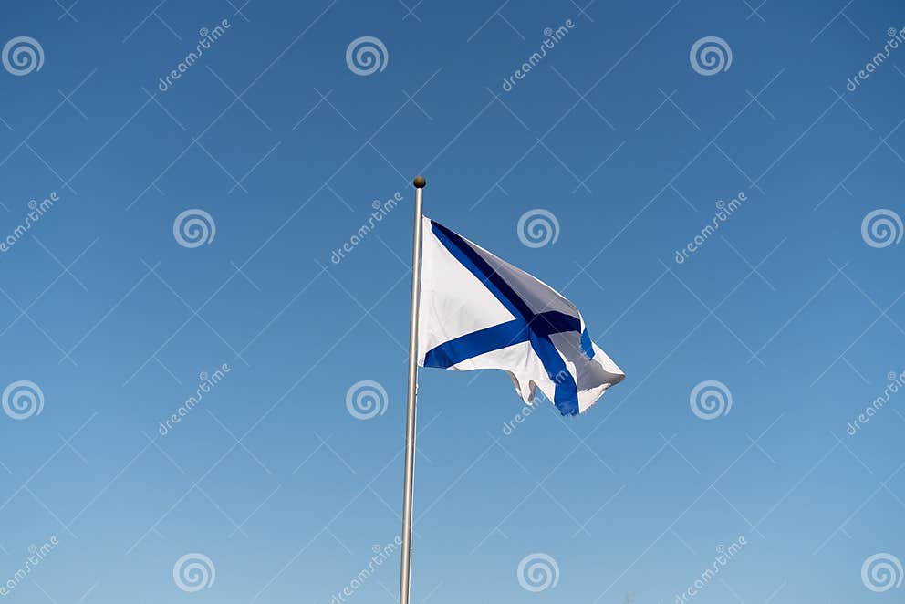 Navy White Flag with Blue Stripes on Blue Sky Background Stock Image