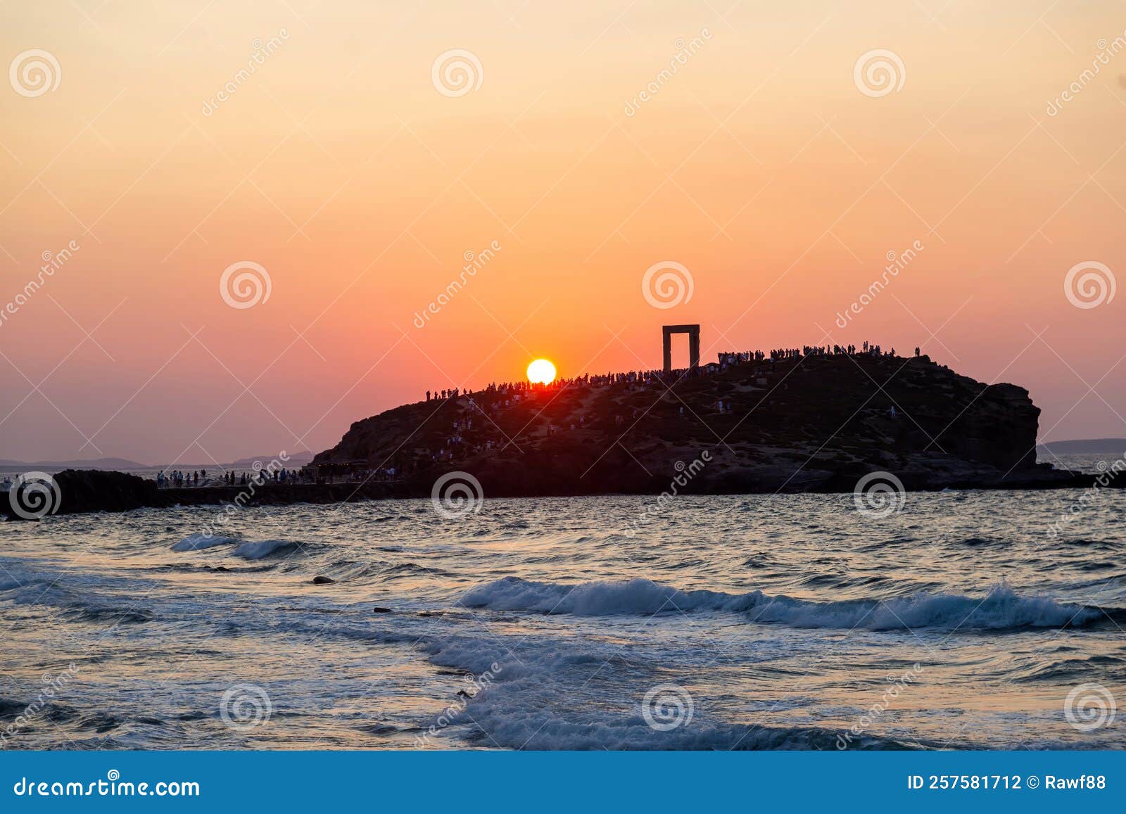 naxos island, sunset over temple of apollo, cyclades greece. visitors admire the sundown background