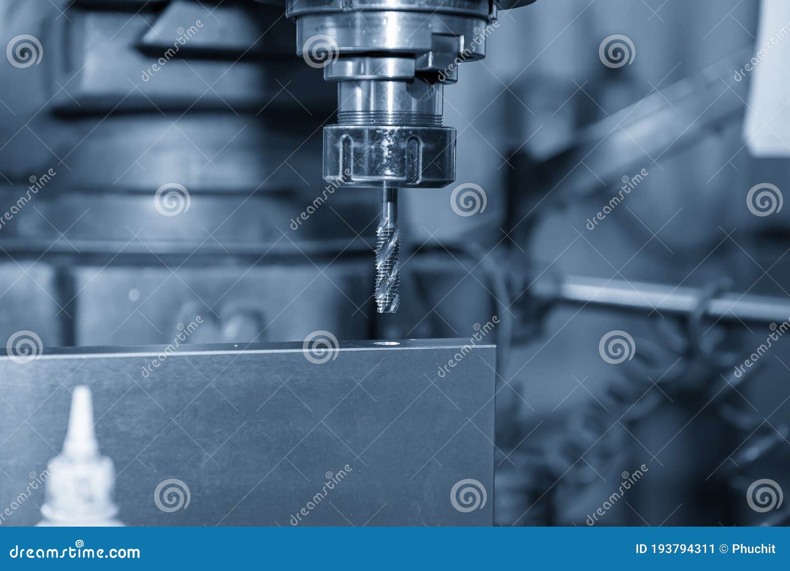 The NC Milling Machine Making the Thread at the Metal Plate by Tapping