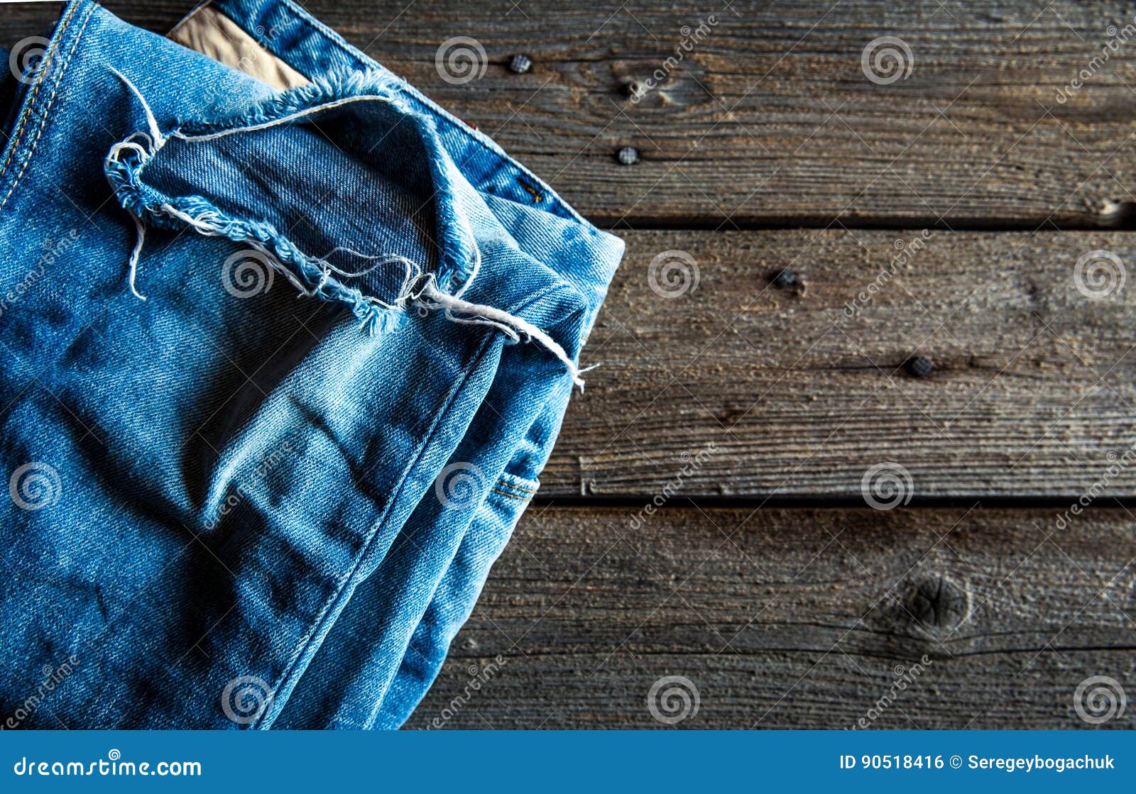 Neatly Folded Jeans on Wooden Background. Clothing, Fashion, Style ...