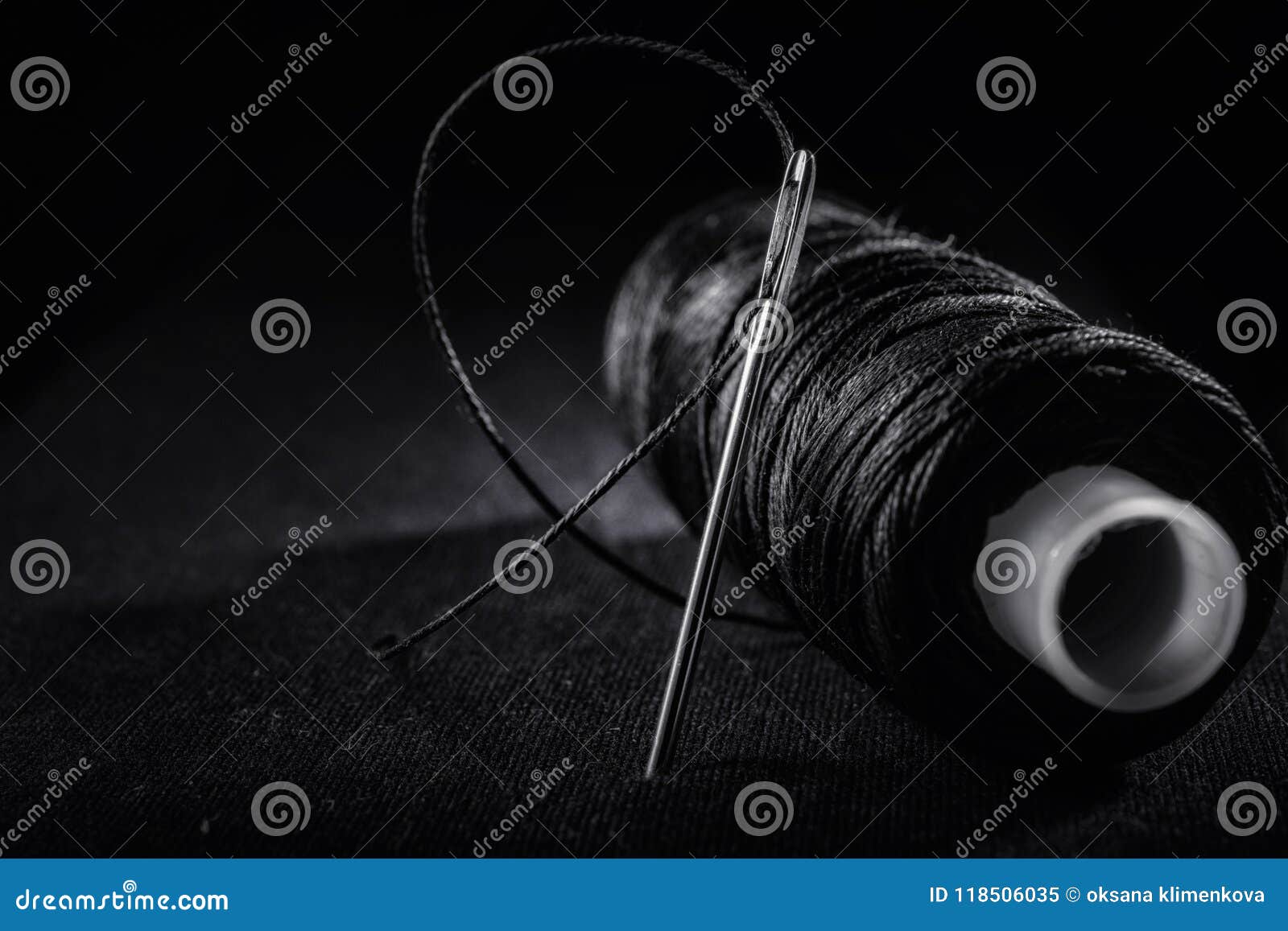 Black Thread Reel with a Needle Stock Photo - Image of object