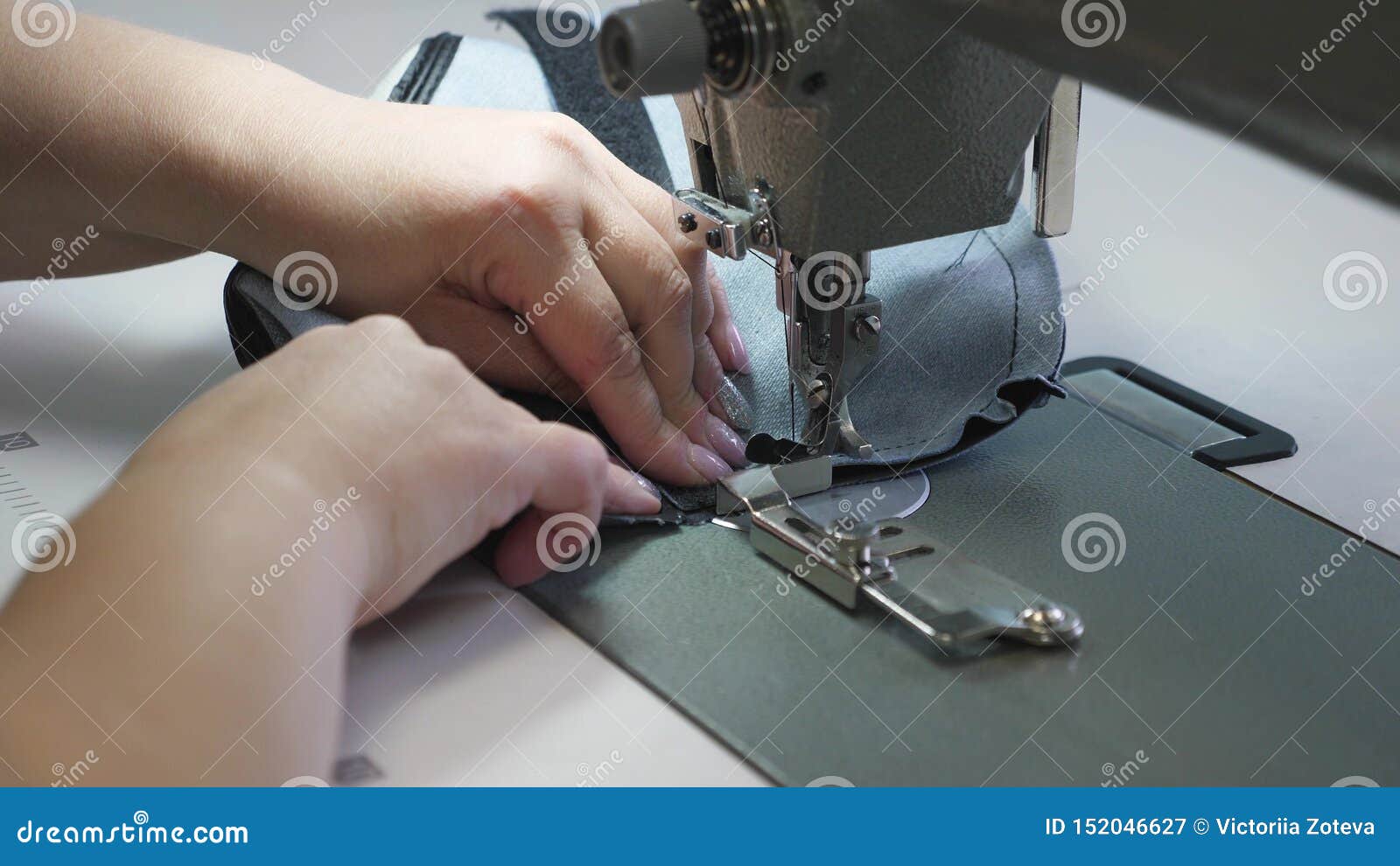 Needle Of The Sewing Machine In Motion, Close-up. Needle Of The Sewing A Sewing Machine Needle Moves Up And Down