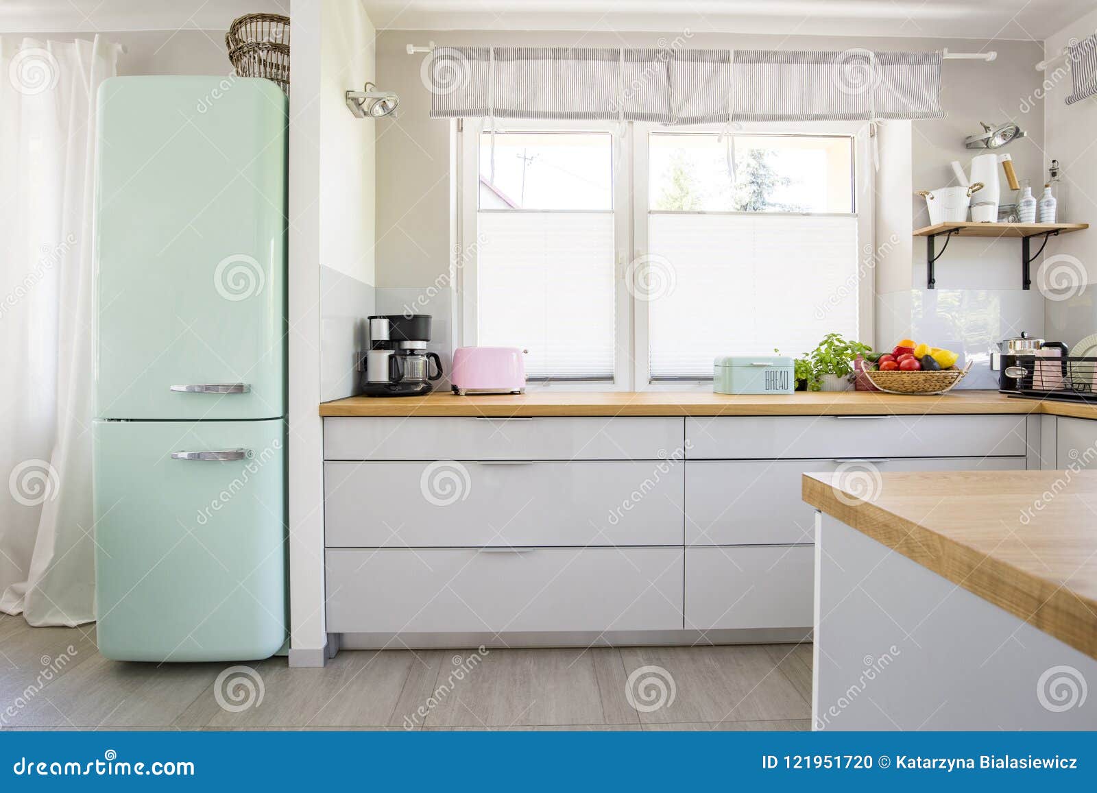 neo mint fridge standing in real photo of bright kitchen interio