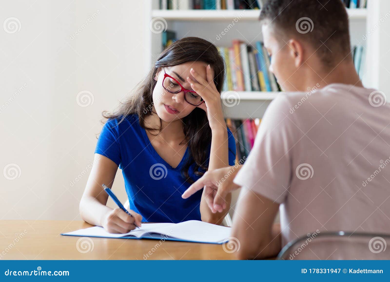 Nerdy Female Student with Eyeglasses Learning with Concentration Stock