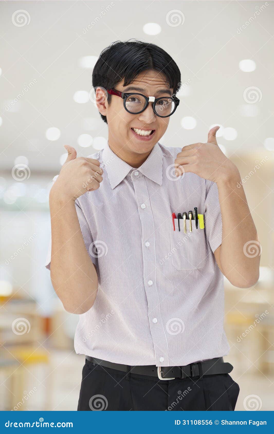 Nerdy Man With Glasses Giving Thumbs Up Looking At Camera