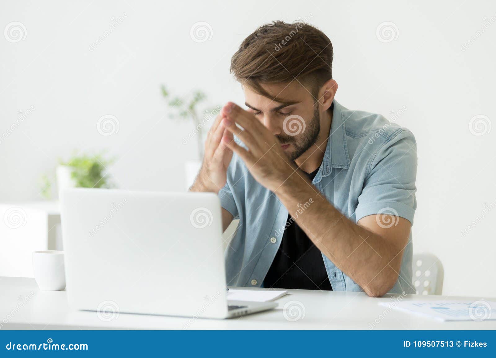 nervous man thinking over problem trying to focus at work