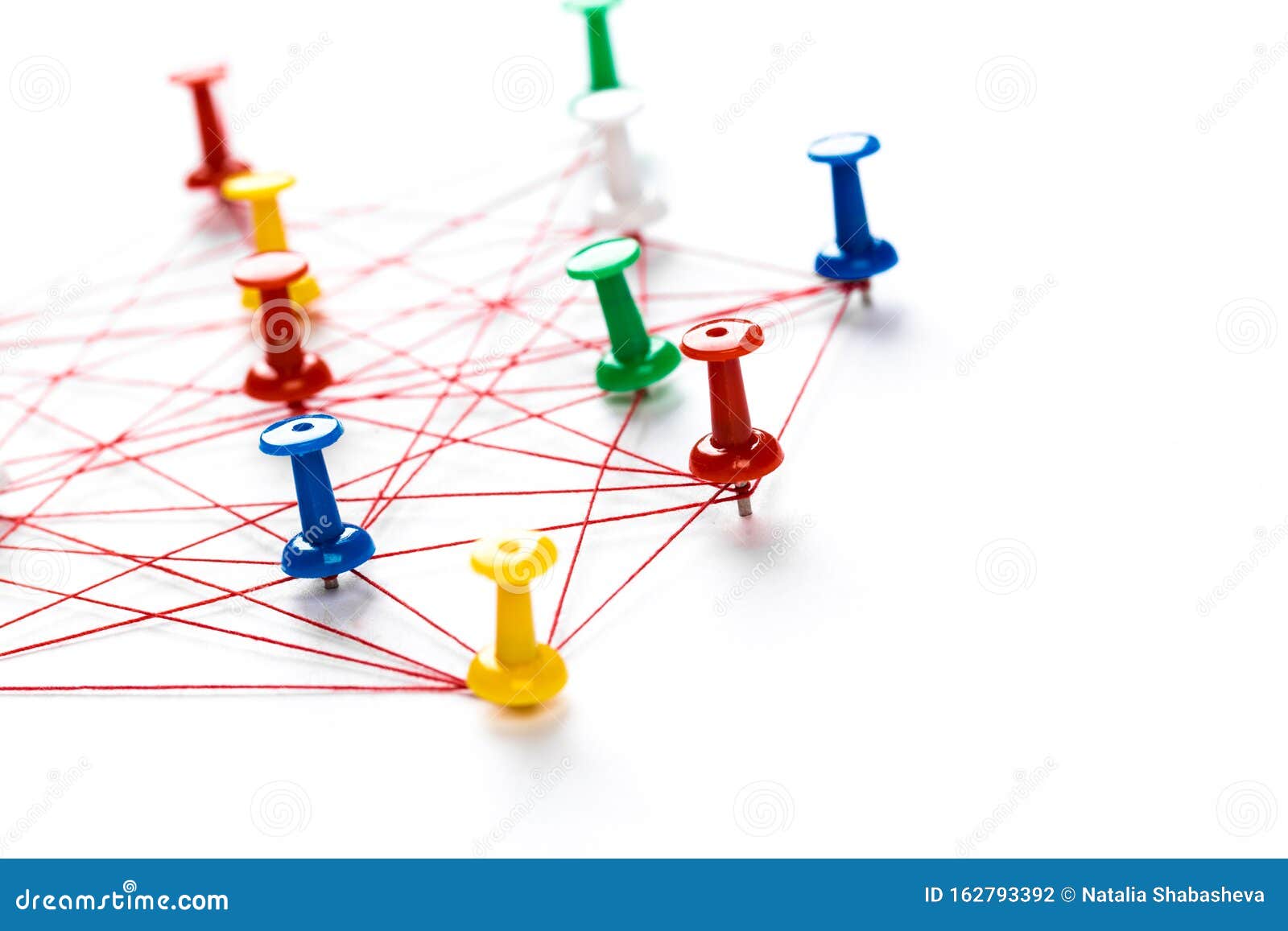 network with colorful pins and string,  linked together with string on a white background suggesting a network of connections