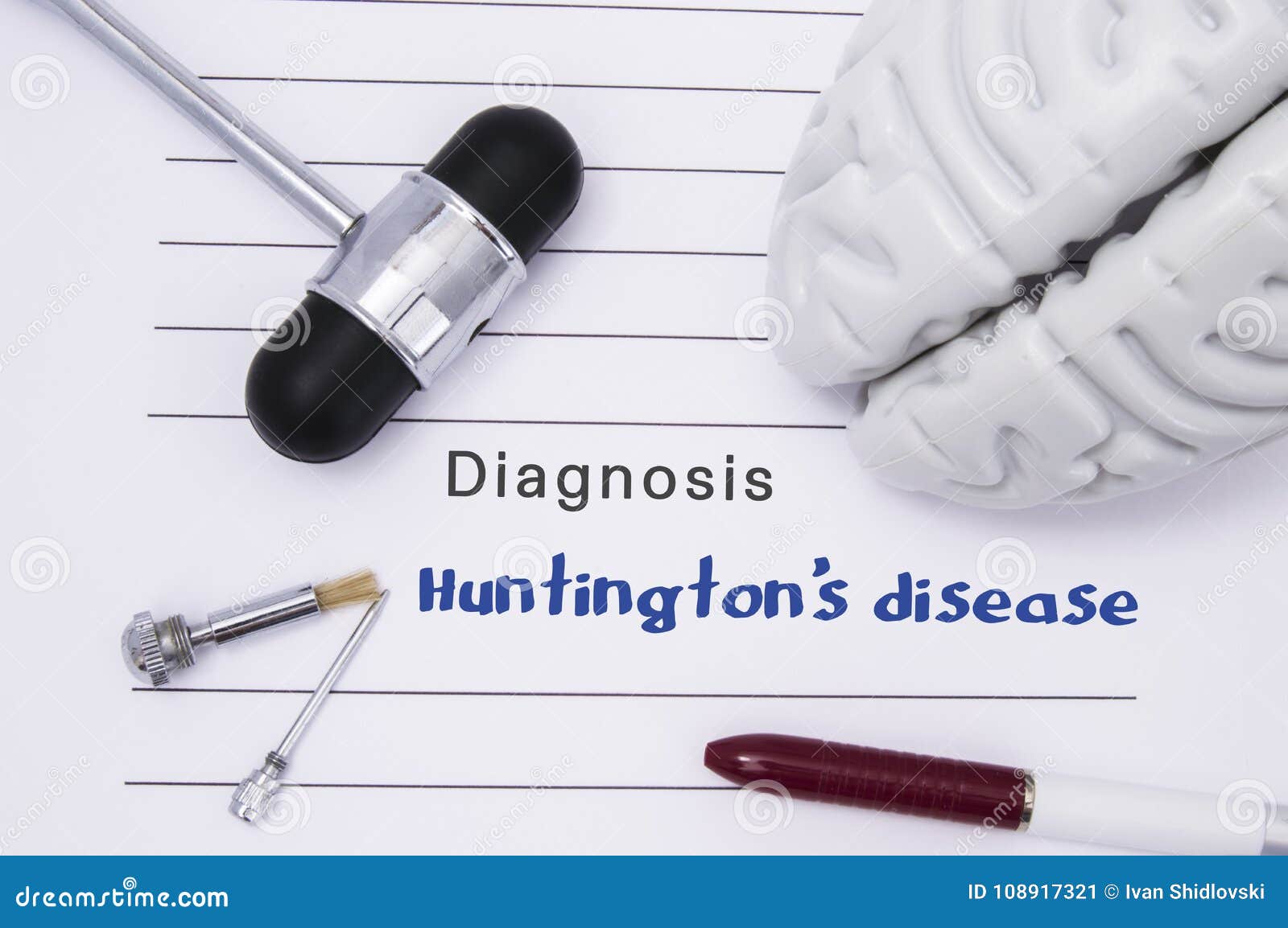 neurological diagnosis of huntington`s disease. neurological hammer, human brain figure, tools for sensitivity testing are on tabl