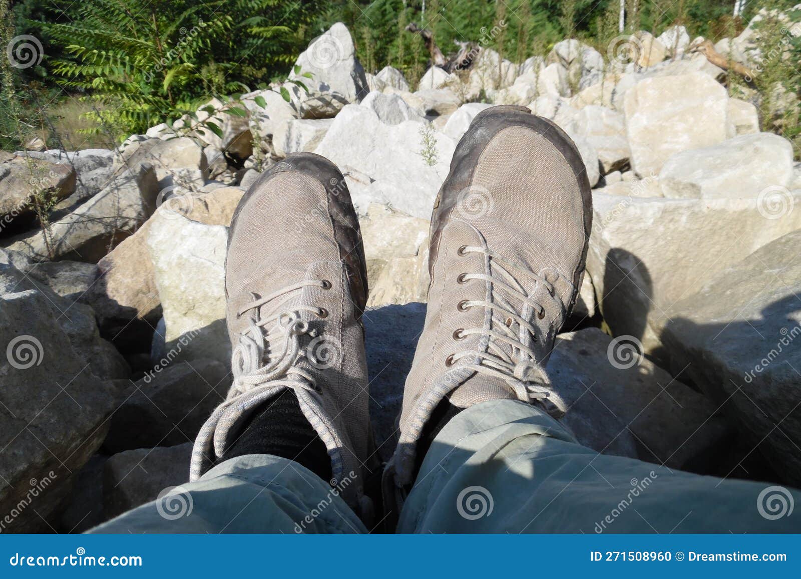 neutral grey barefoot running shoes . foot view with white stoned background . natural grey sandy stone colors matching with shoes