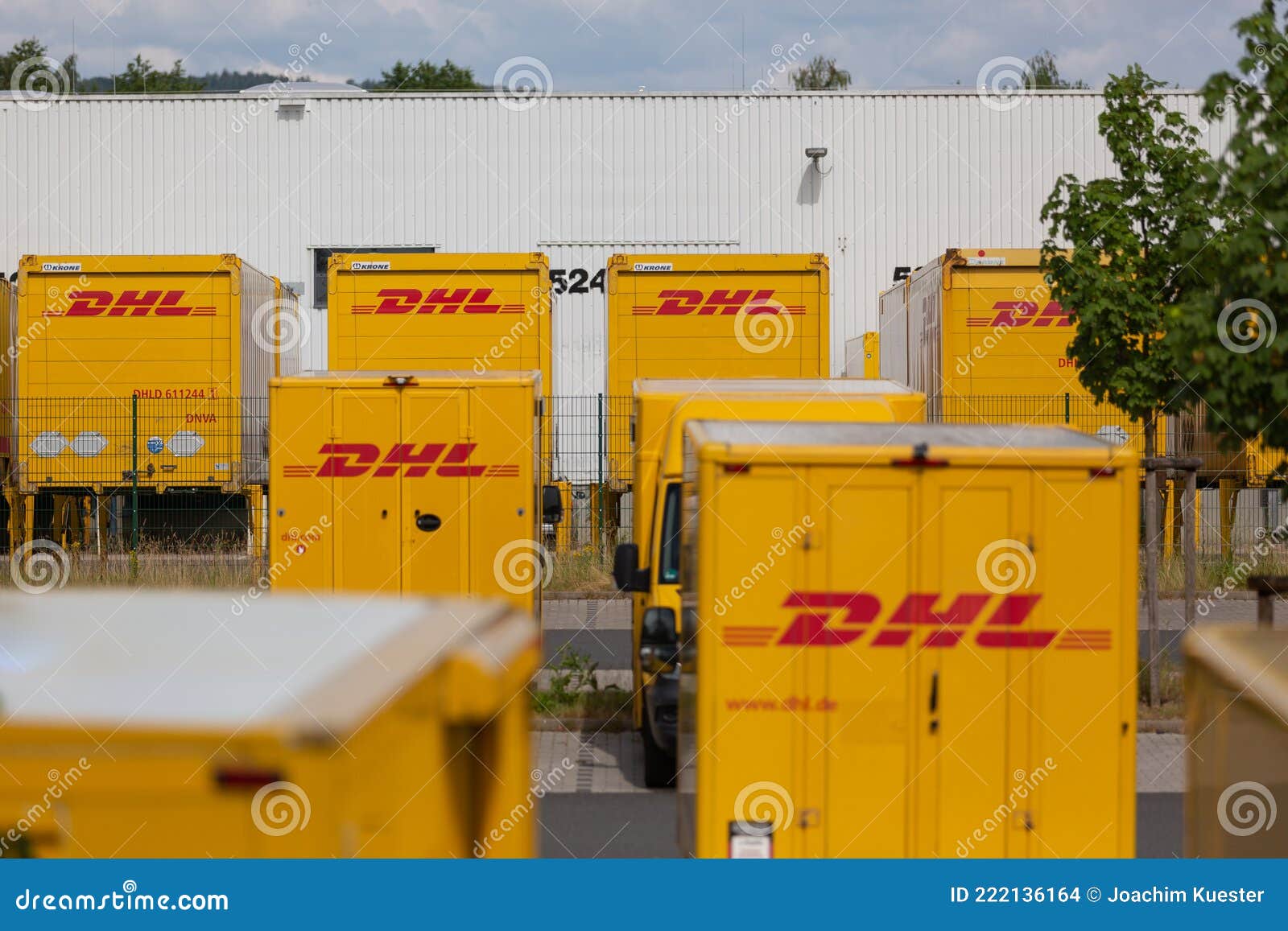 DHL Delivery Vans and Containers in Front of a DHL Depot Editorial ...