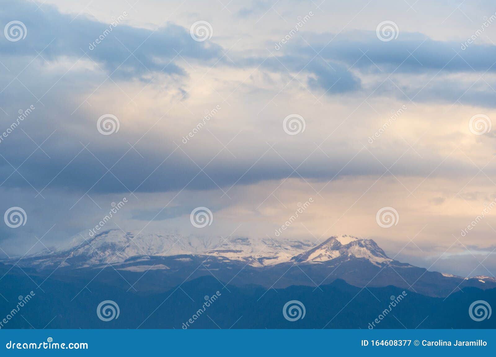 nevado del ruiz, a colombian snow-covered volcano, under a cloudy sky