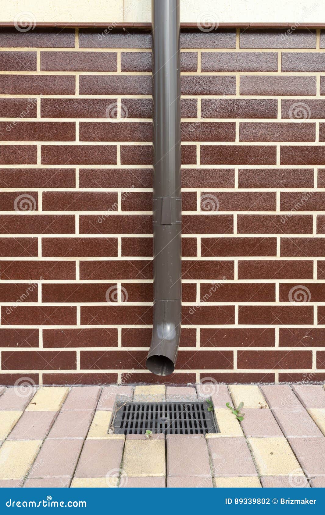 New Brown Copper Drain in a House with Brickwork. Stock Photo - Image