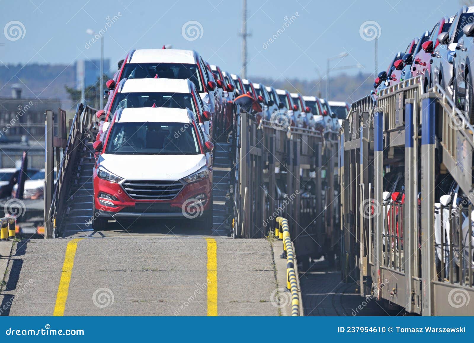 transportation of new cars on railway platforms.