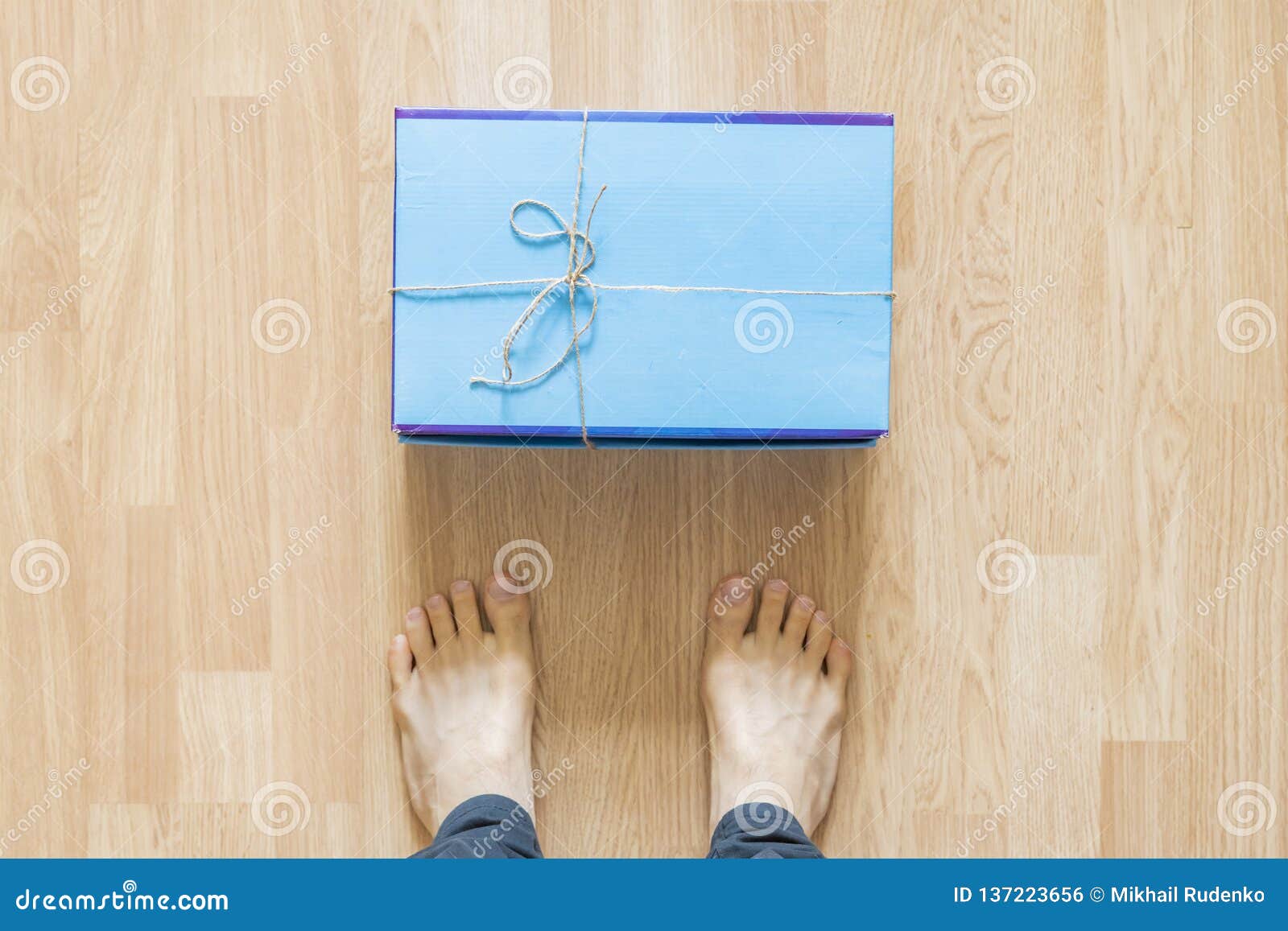 New Delievered Parcel Lay In Front Of Legs Indoors On The Floor F