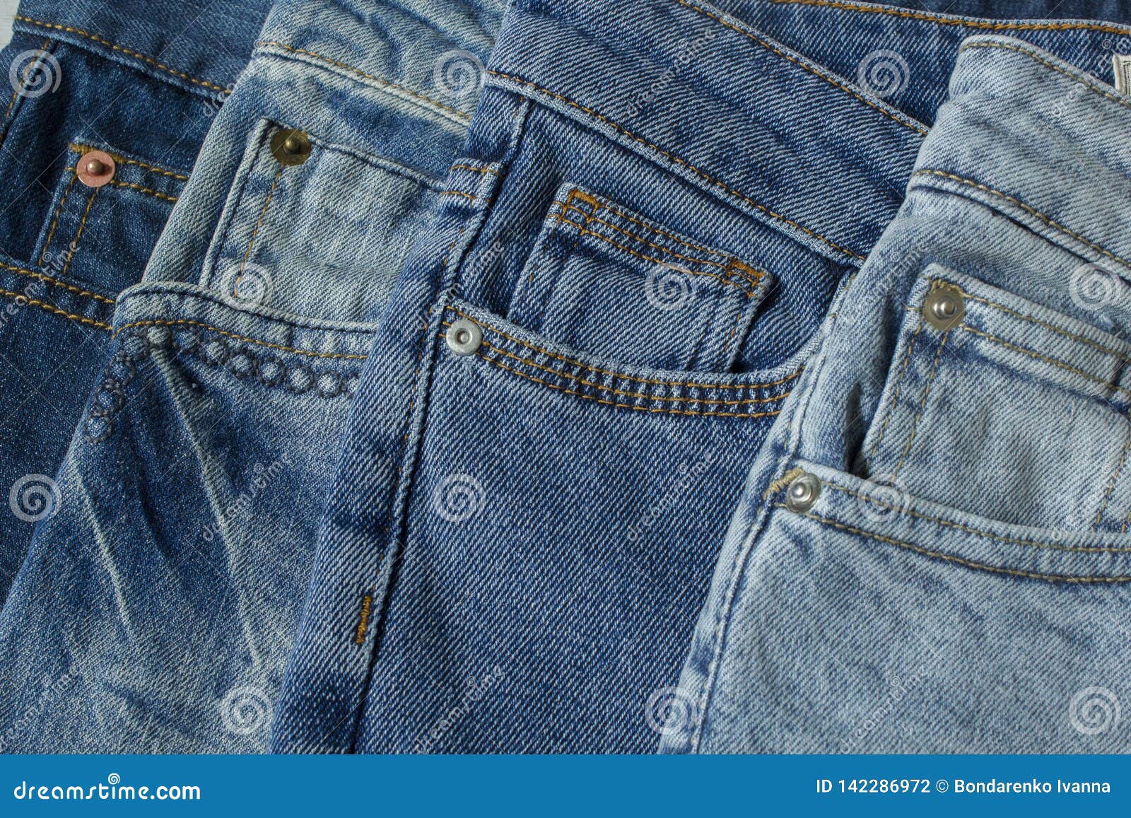 New Denim Pants Clothes Pile Background. Stack of Blue Jeans Different ...