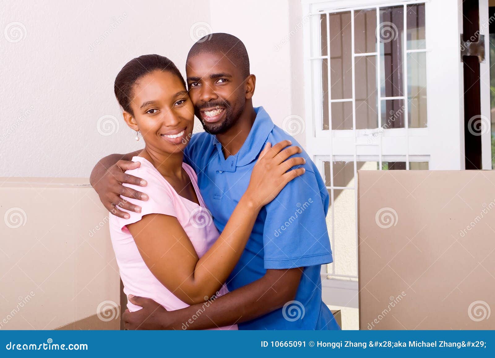 Cute couple hugging and smiling in their new home. Moving to new