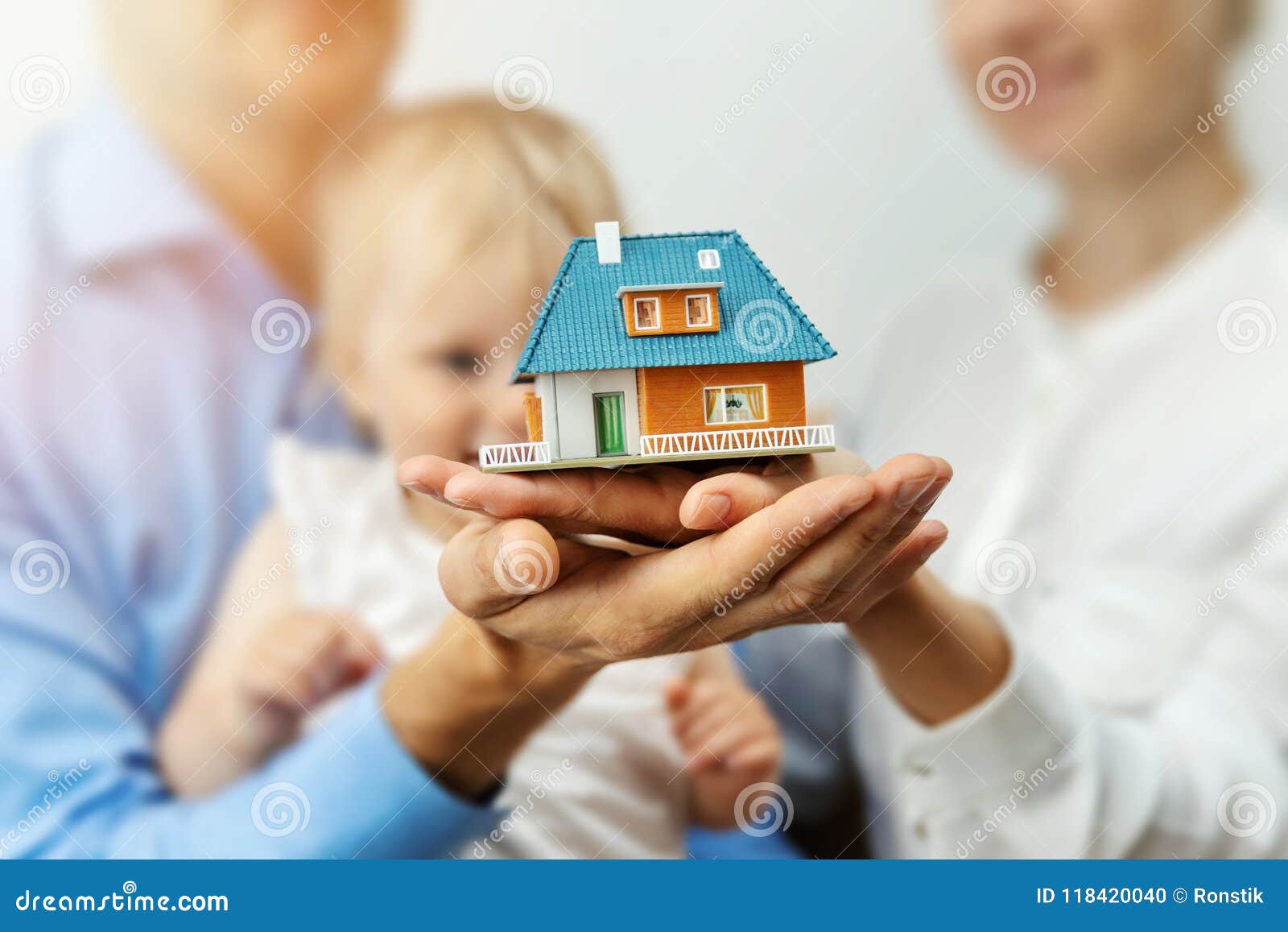new home concept - young family with dream house scale model