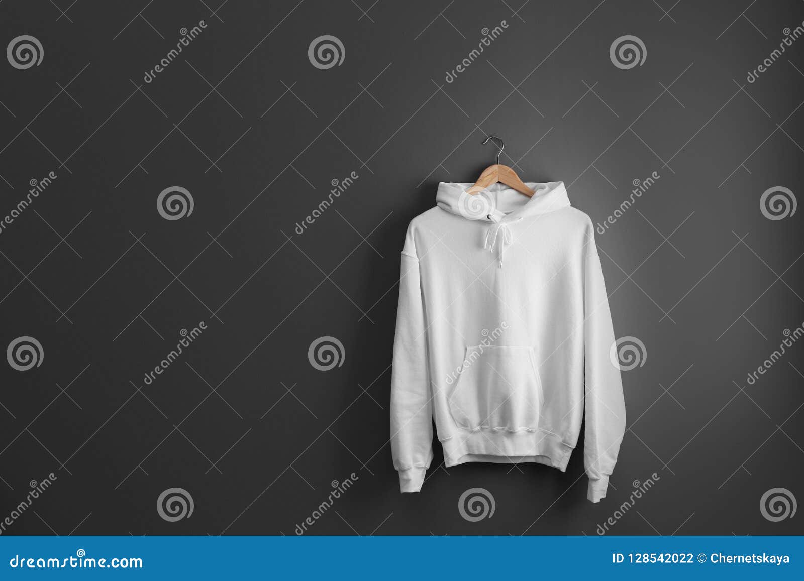 New Hoodie Sweater With Hanger On Grey Wall Stock Photo ...