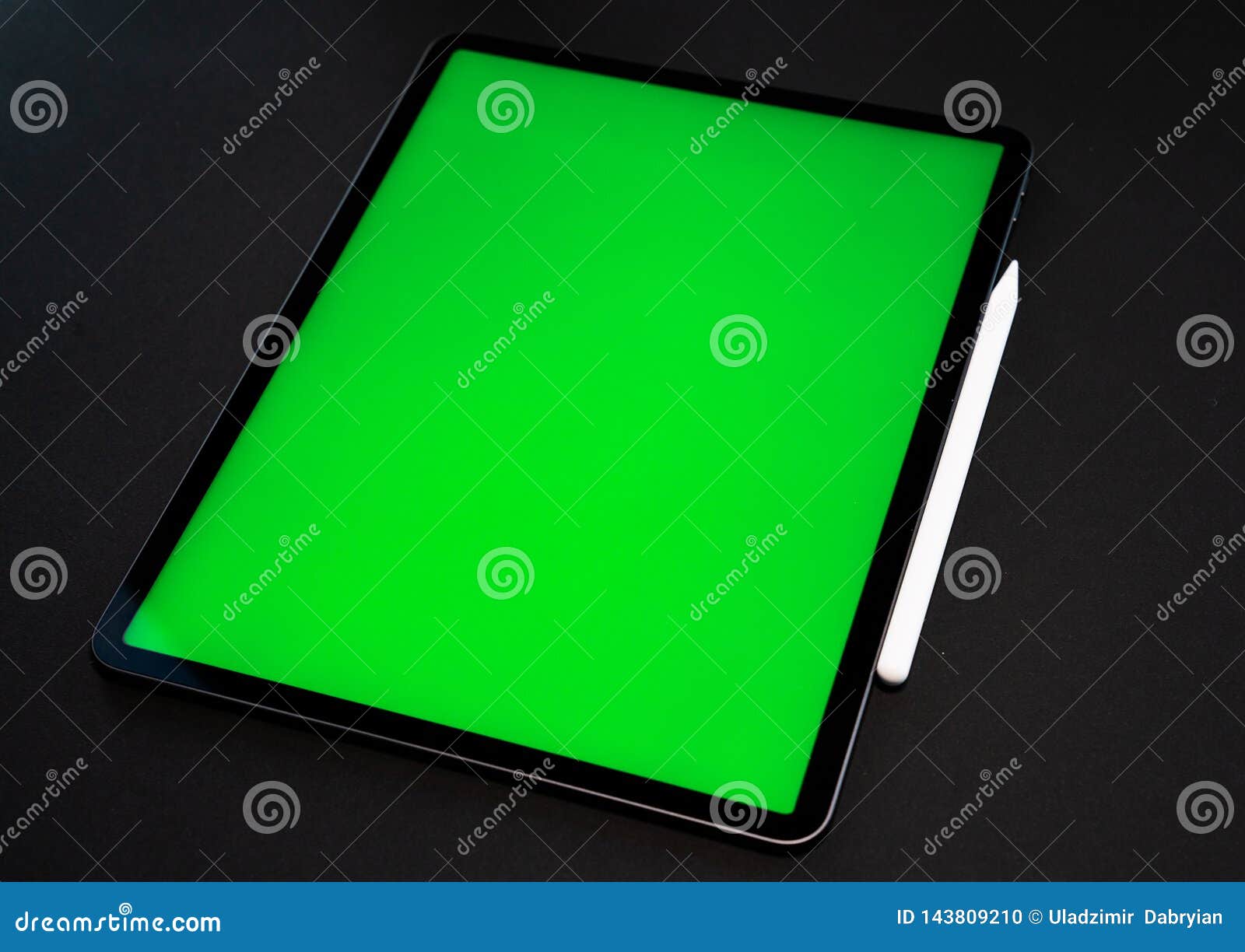 IPad and IPhone, New Tablet on a Black Background with a Pen, and Green