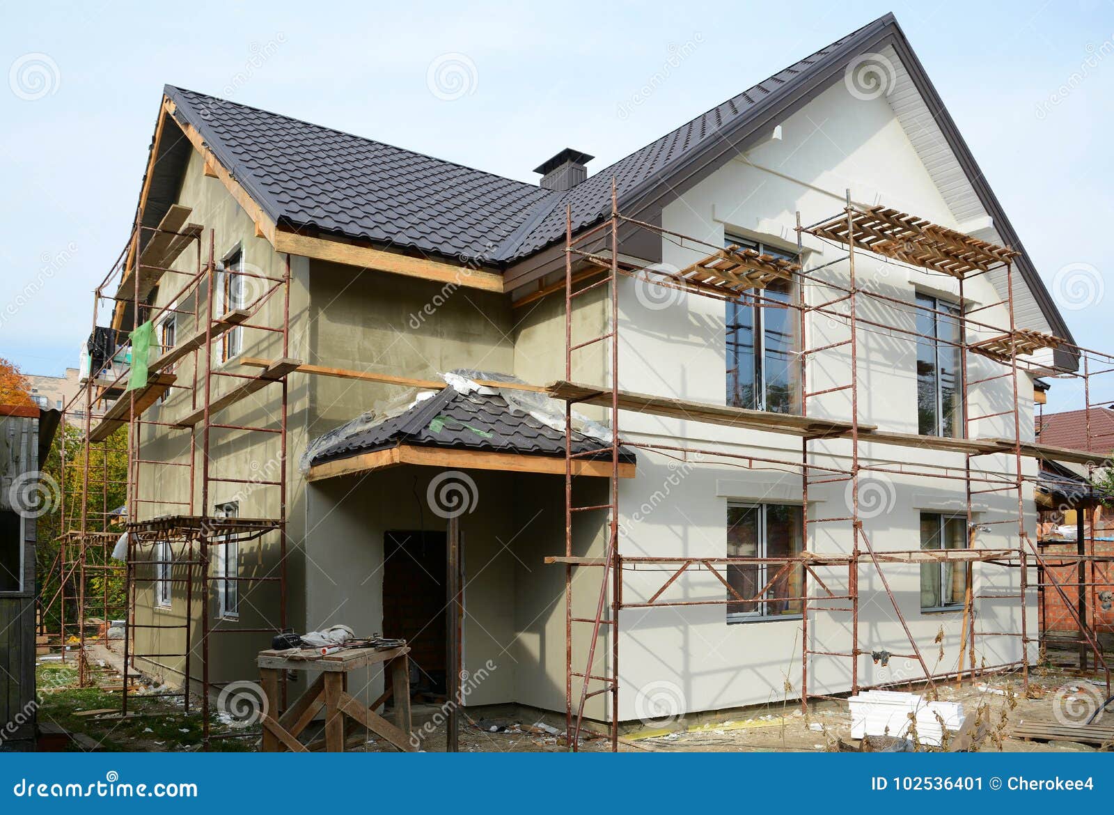 new modern house building home. roof construction. metal chimney. insulated and plastered facade. metal house roof.