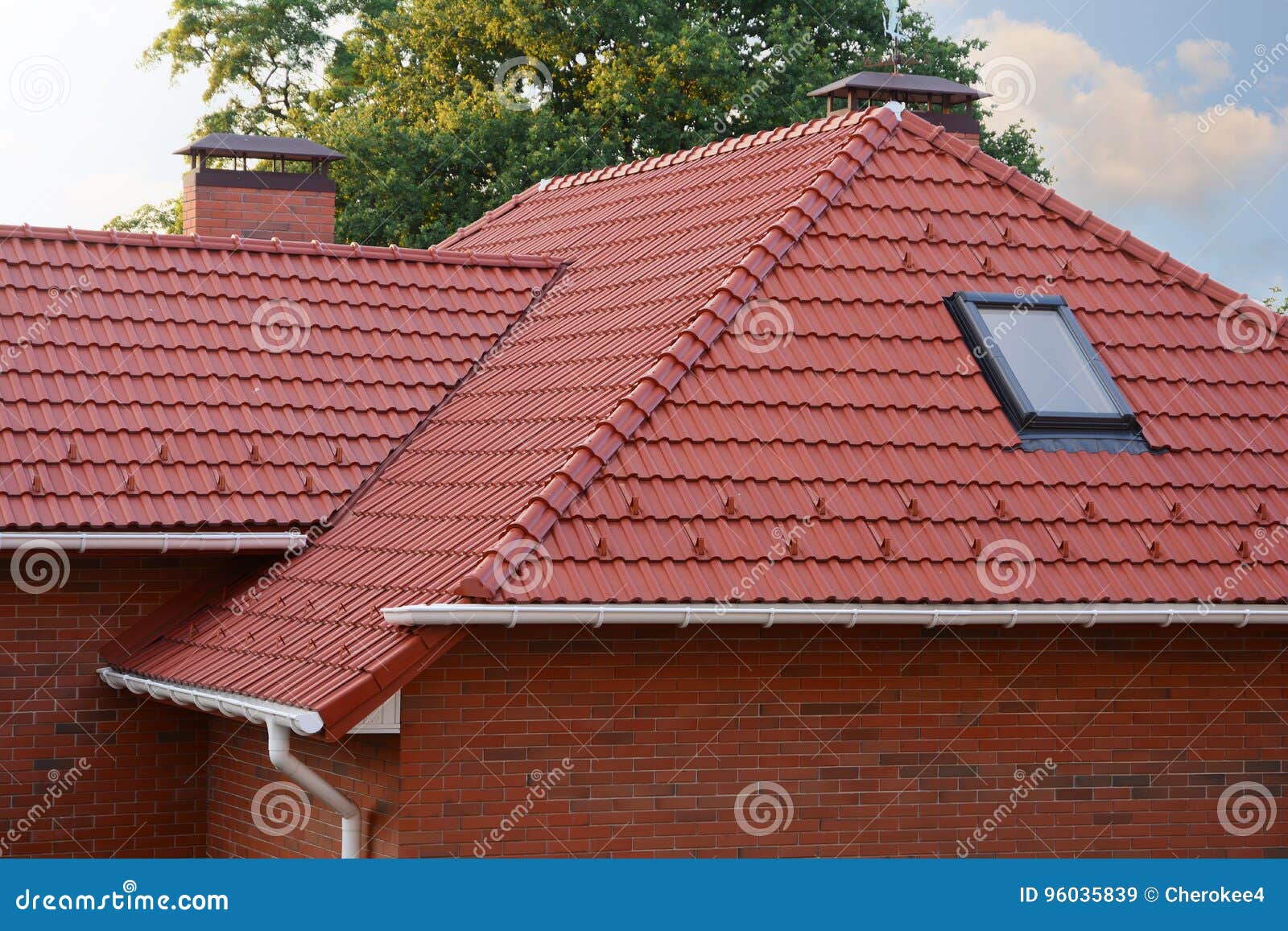 new red shingles roof with skylights windows and rain gutter. new brick house with chimney