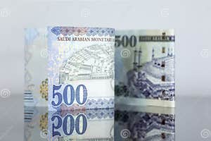 Saudi Riyal Pounds With A Golden One On A Reflective Surface Stock 