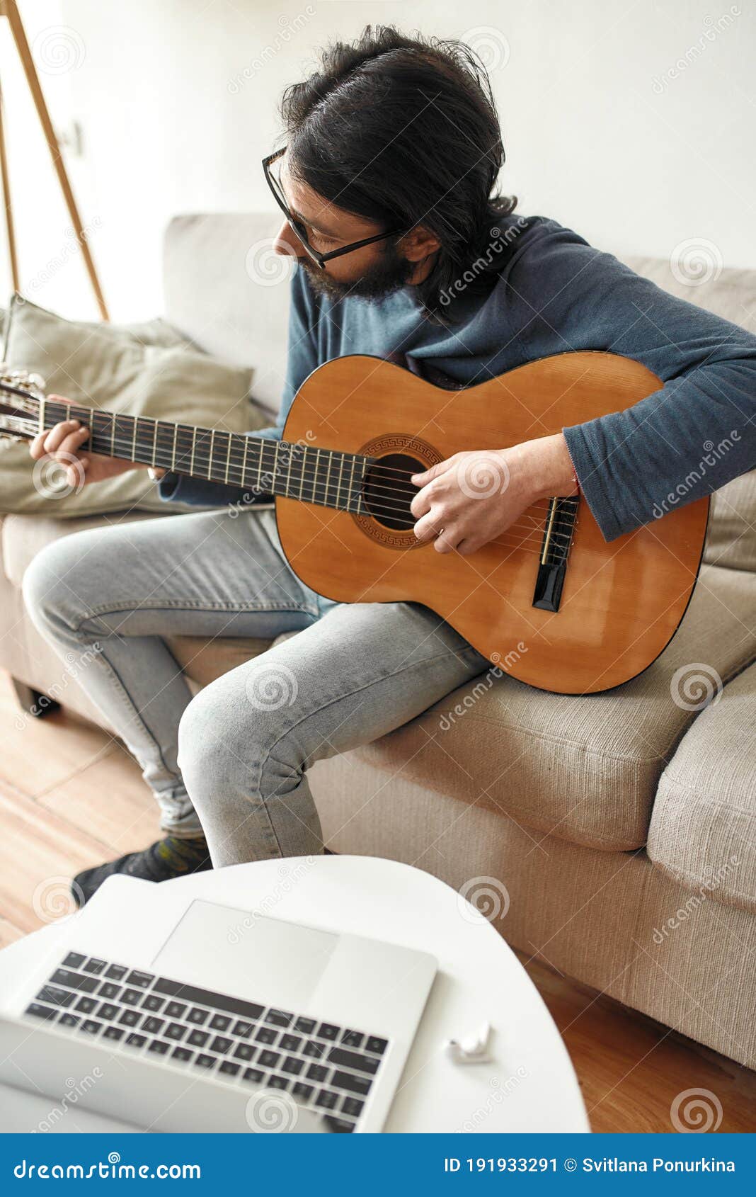 New Skill Young Focused Man Sitting On Sofa At Home And Playing Acoustic Guitar Watching Online Music Course On Laptop Stock Image Image Of Covid19 Guitarist